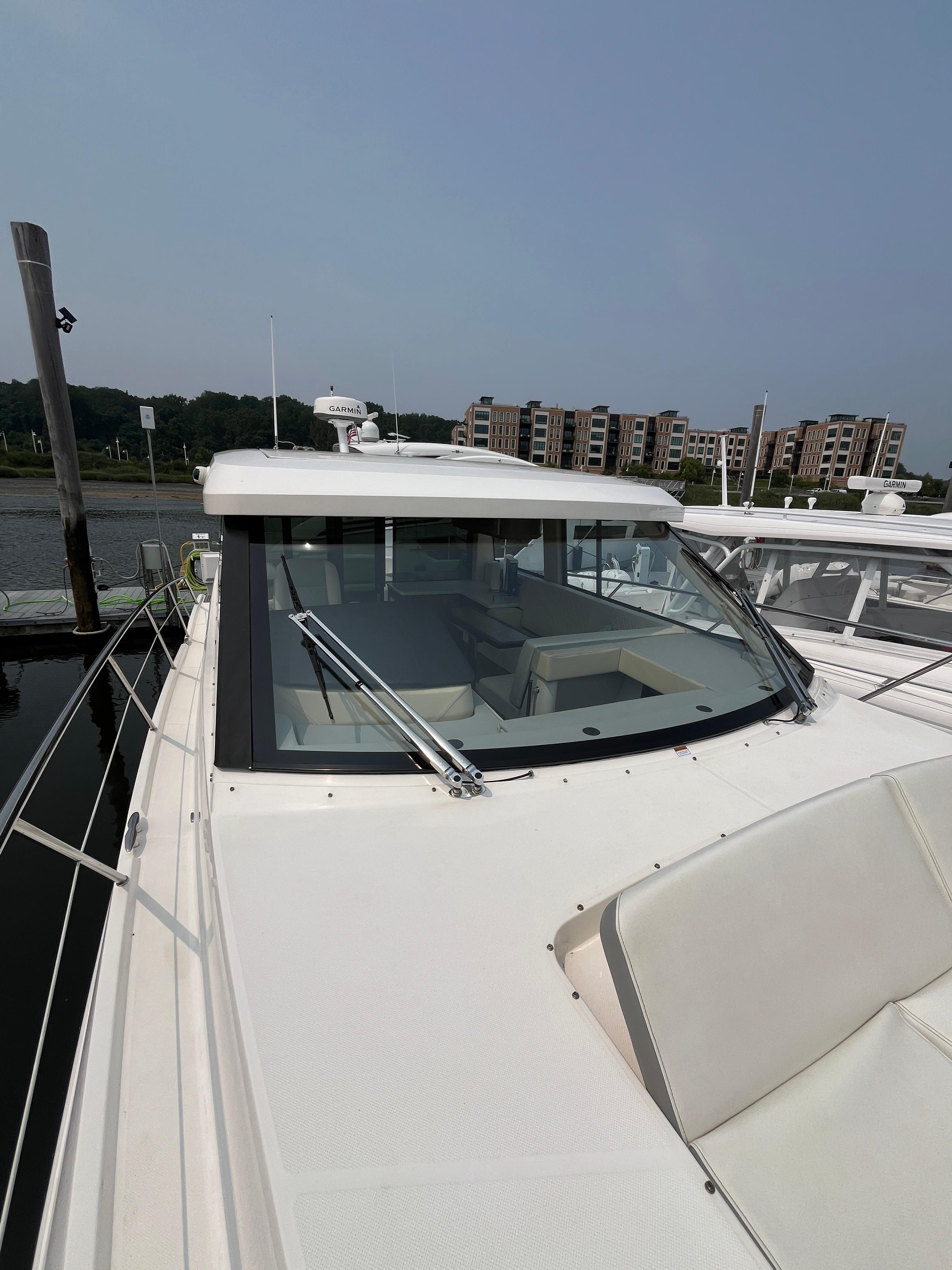 2022 Regal 38 XO yacht docked, showcasing sleek design and spacious deck.