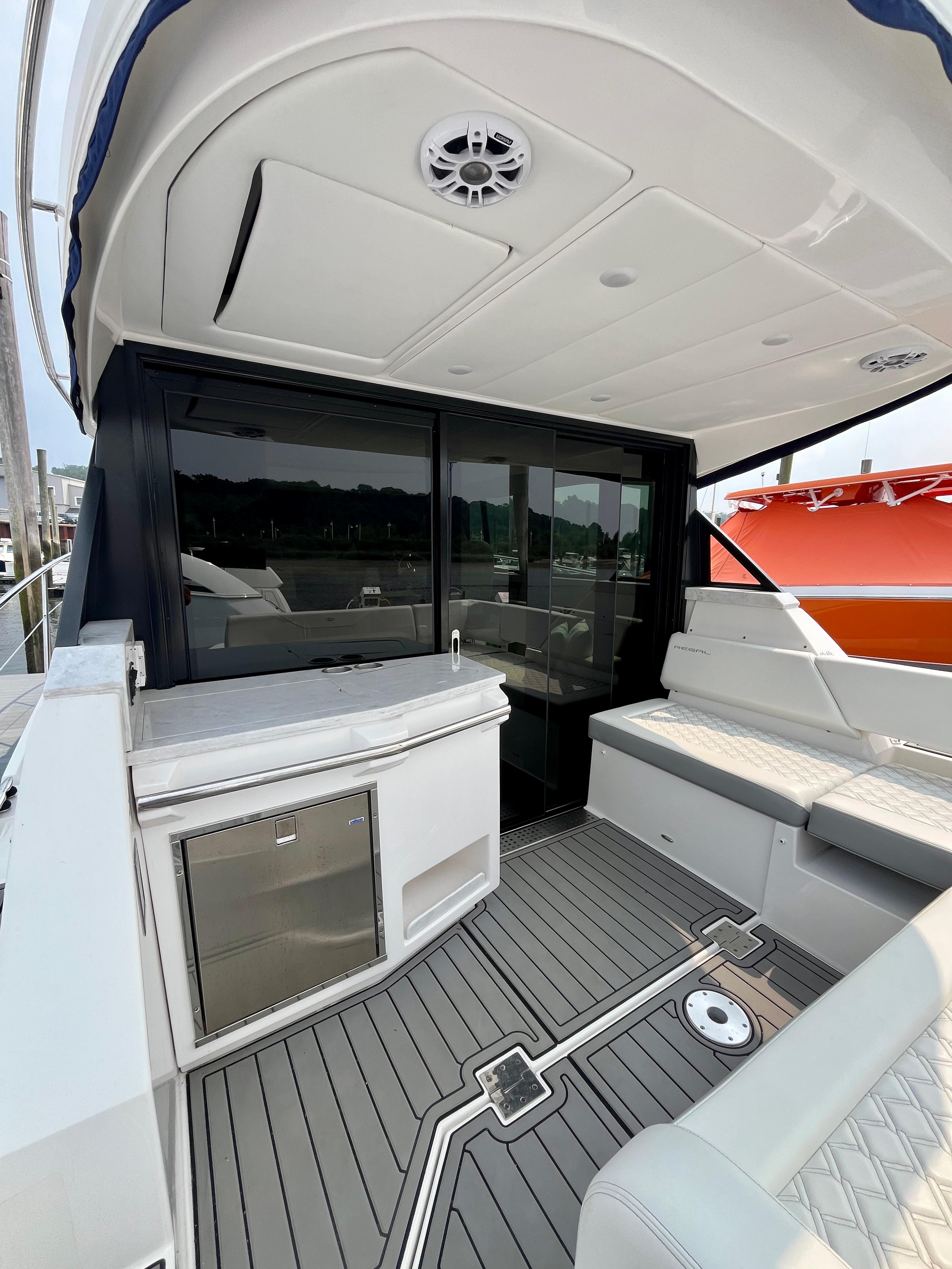 2022 Regal 38 XO yacht interior with seating, kitchenette, and modern design.