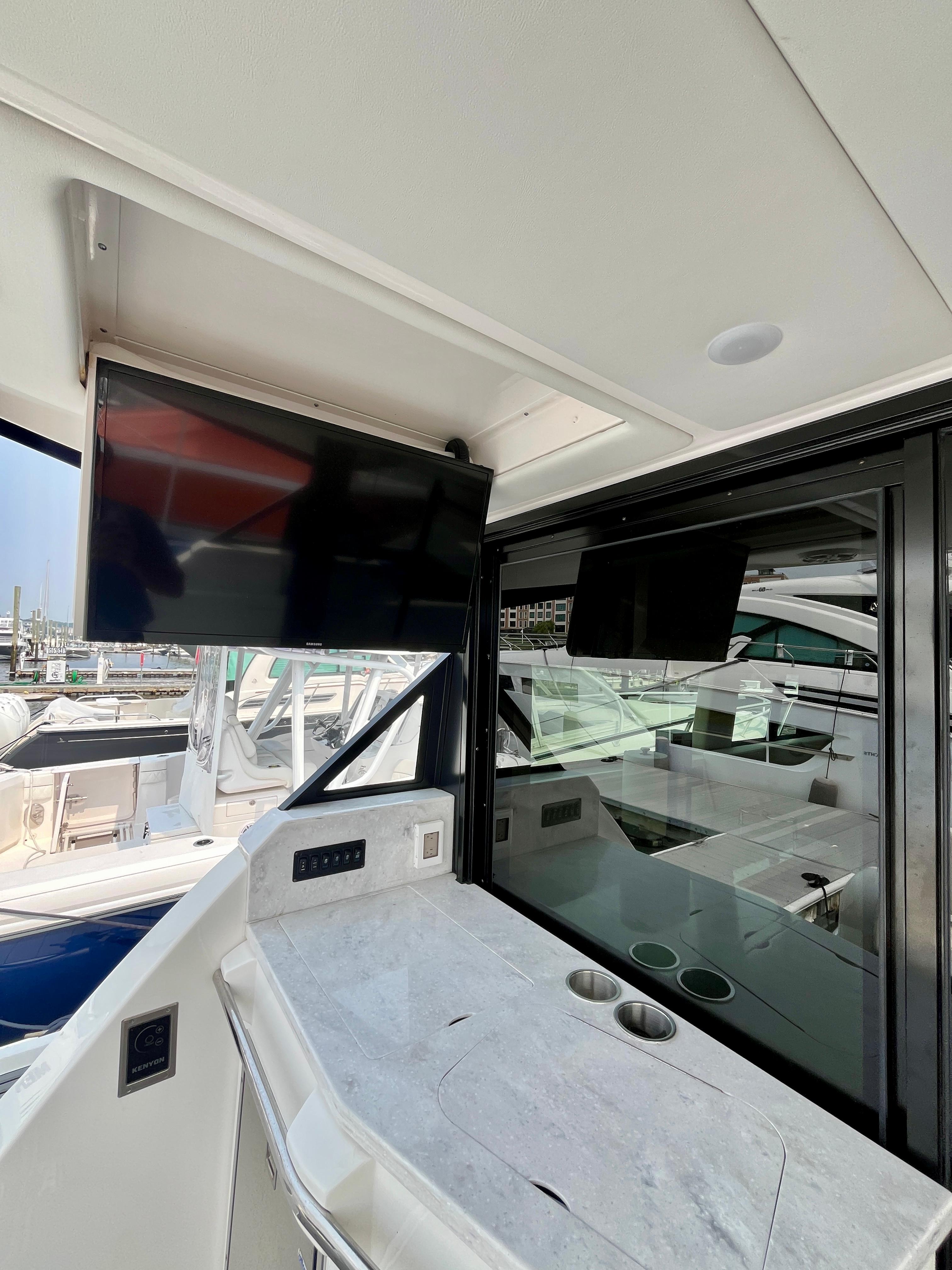 2022 Regal 38 XO yacht interior with TV and sleek countertop.