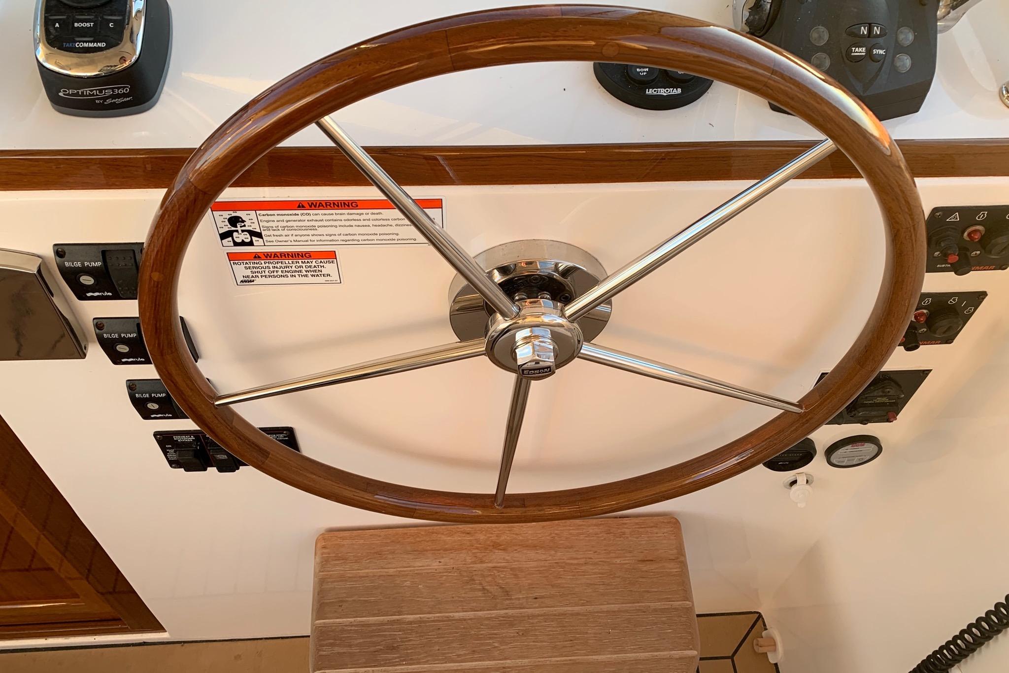 Steering wheel of 2015 MJM 36z Express boat with control panel and gauges.
