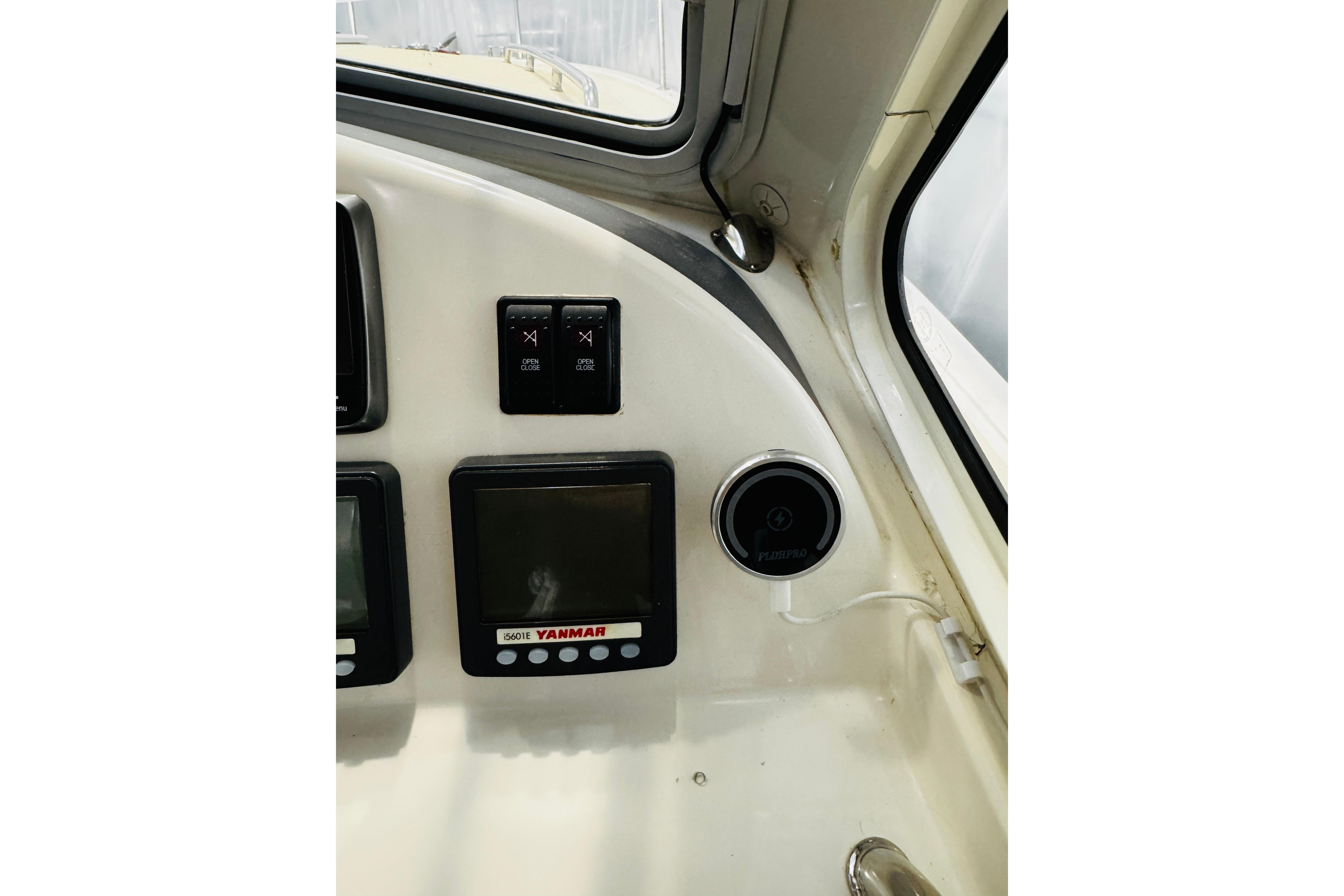 2015 MJM 36z Express dashboard with Yanmar display and controls.