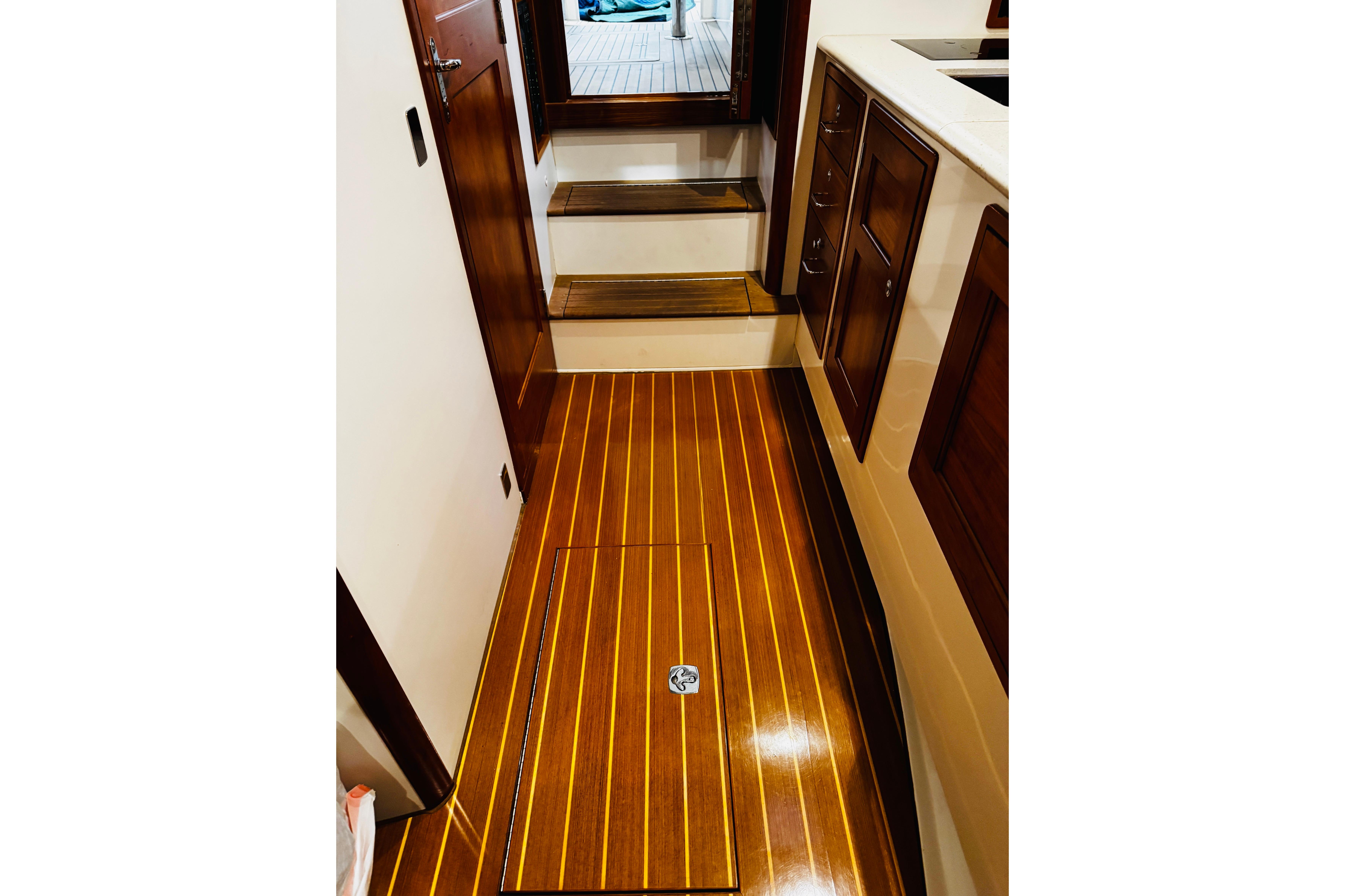2015 MJM 36z Express interior with polished wooden flooring and cabinetry.