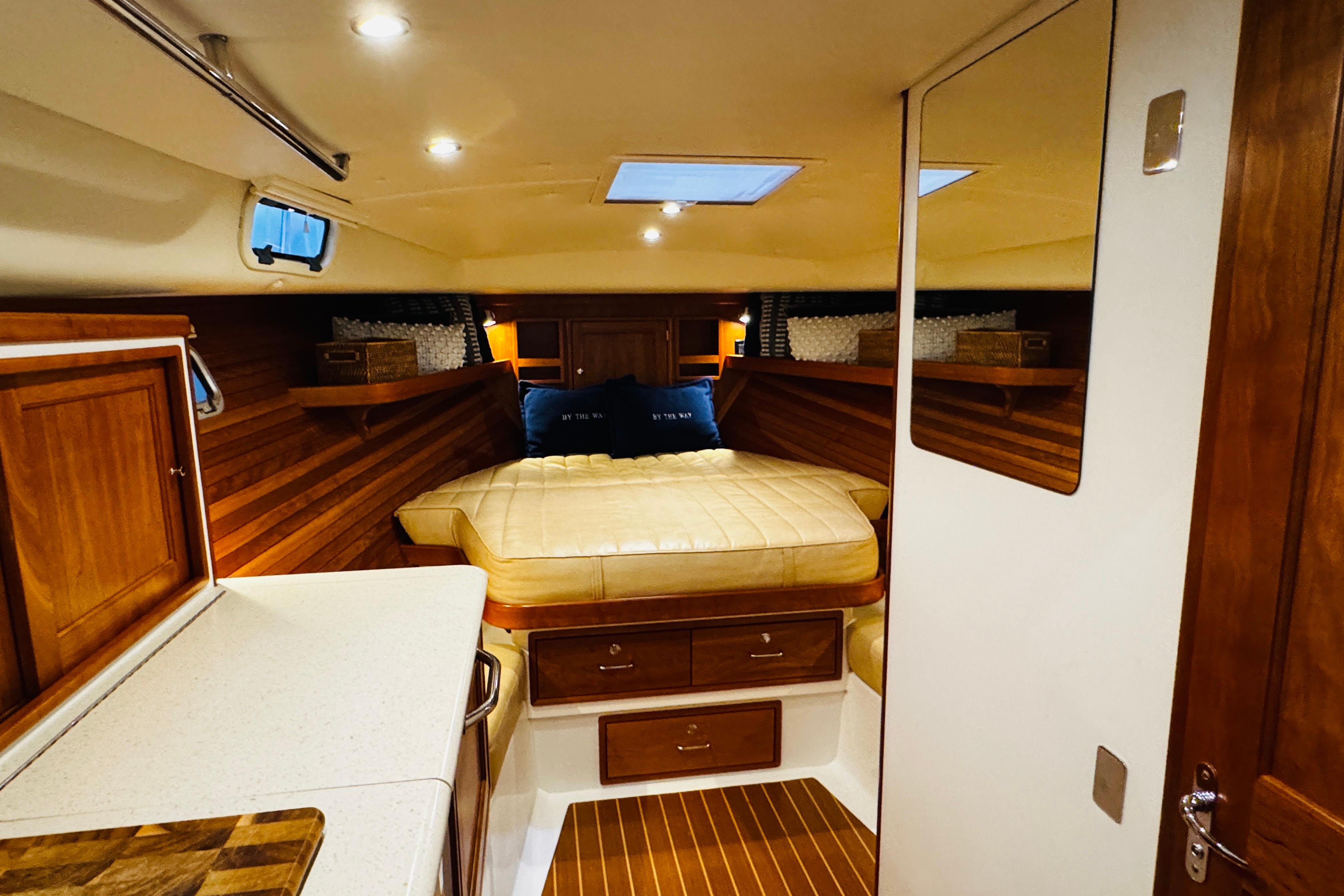 Luxurious cabin interior of 2015 MJM 36z Express yacht with cozy bed and wooden finishes.