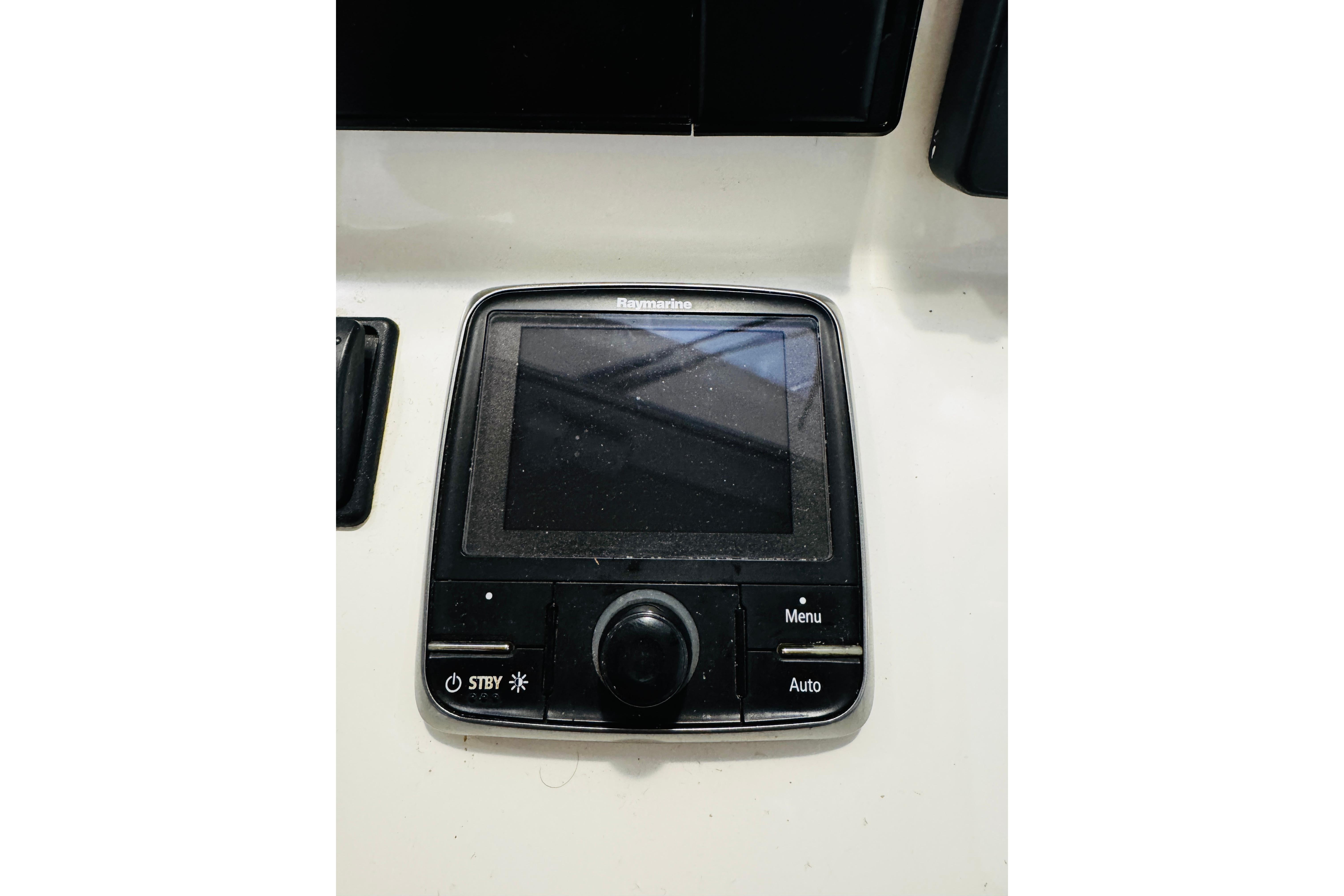 Raymarine control panel on 2015 MJM 36z Express boat dashboard.
