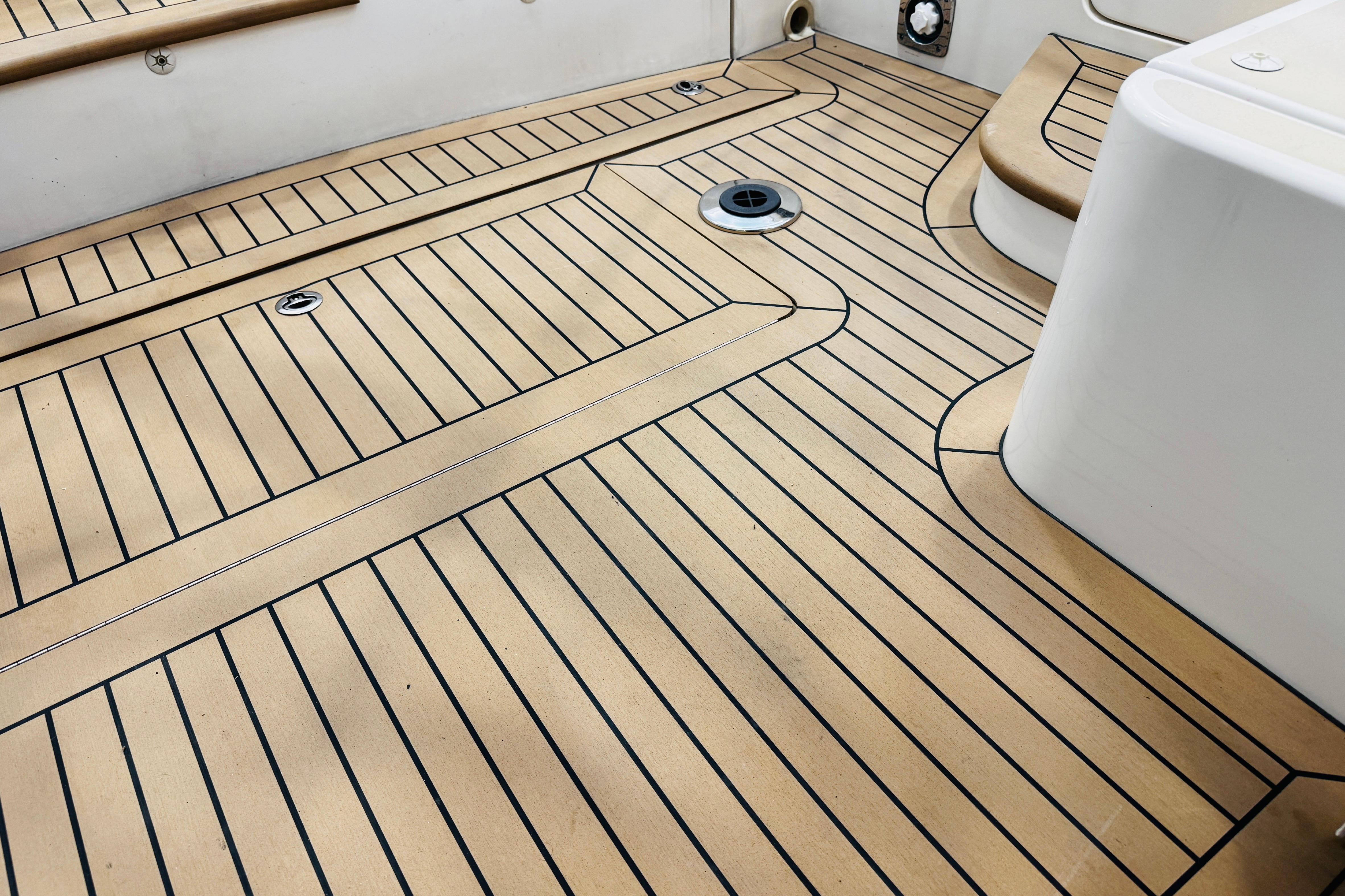 Teak deck of 2015 MJM 36z Express boat, showcasing elegant wood pattern and craftsmanship.