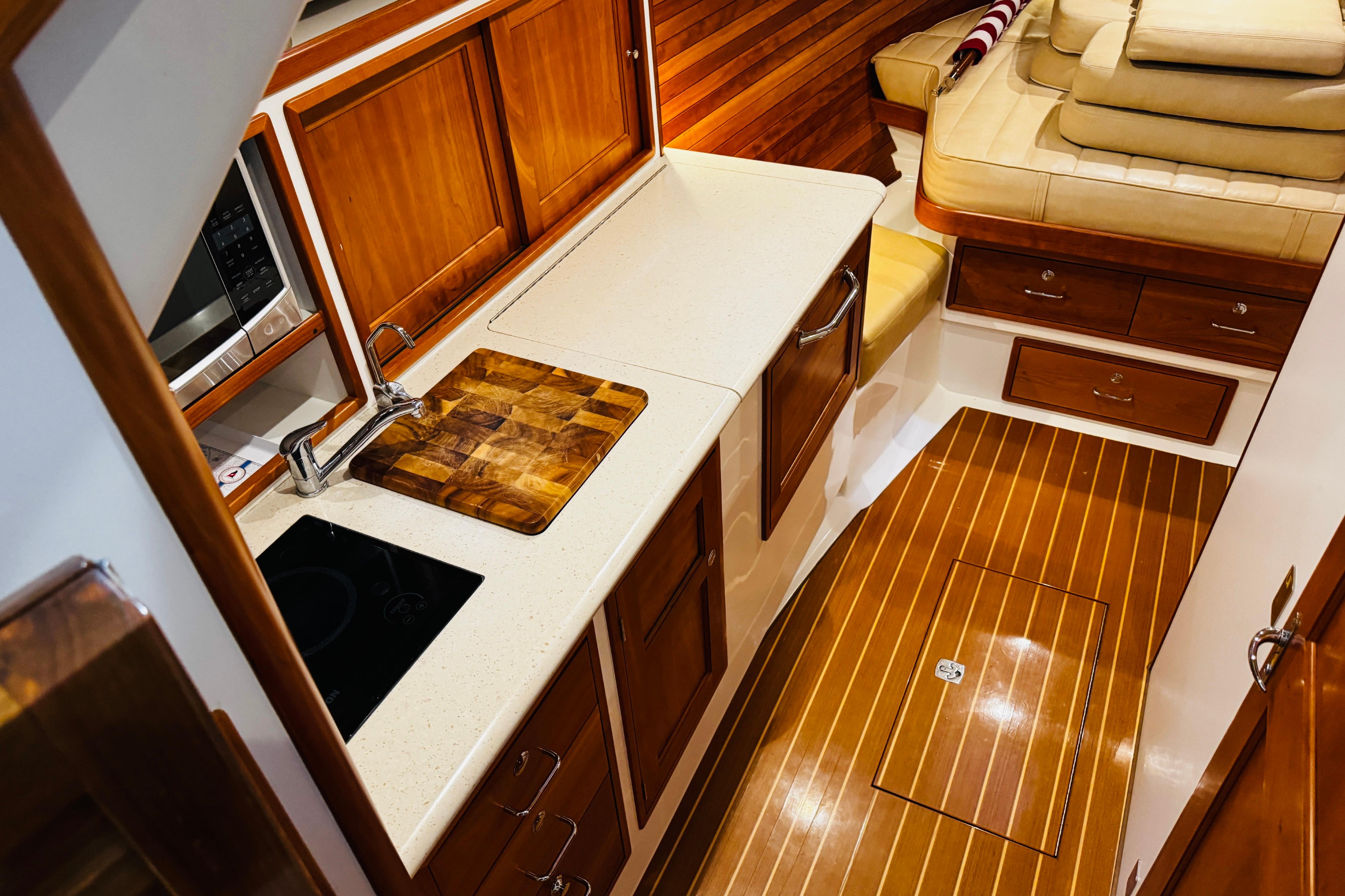 Luxurious interior of 2015 MJM 36z Express yacht with wooden cabinetry and modern amenities.