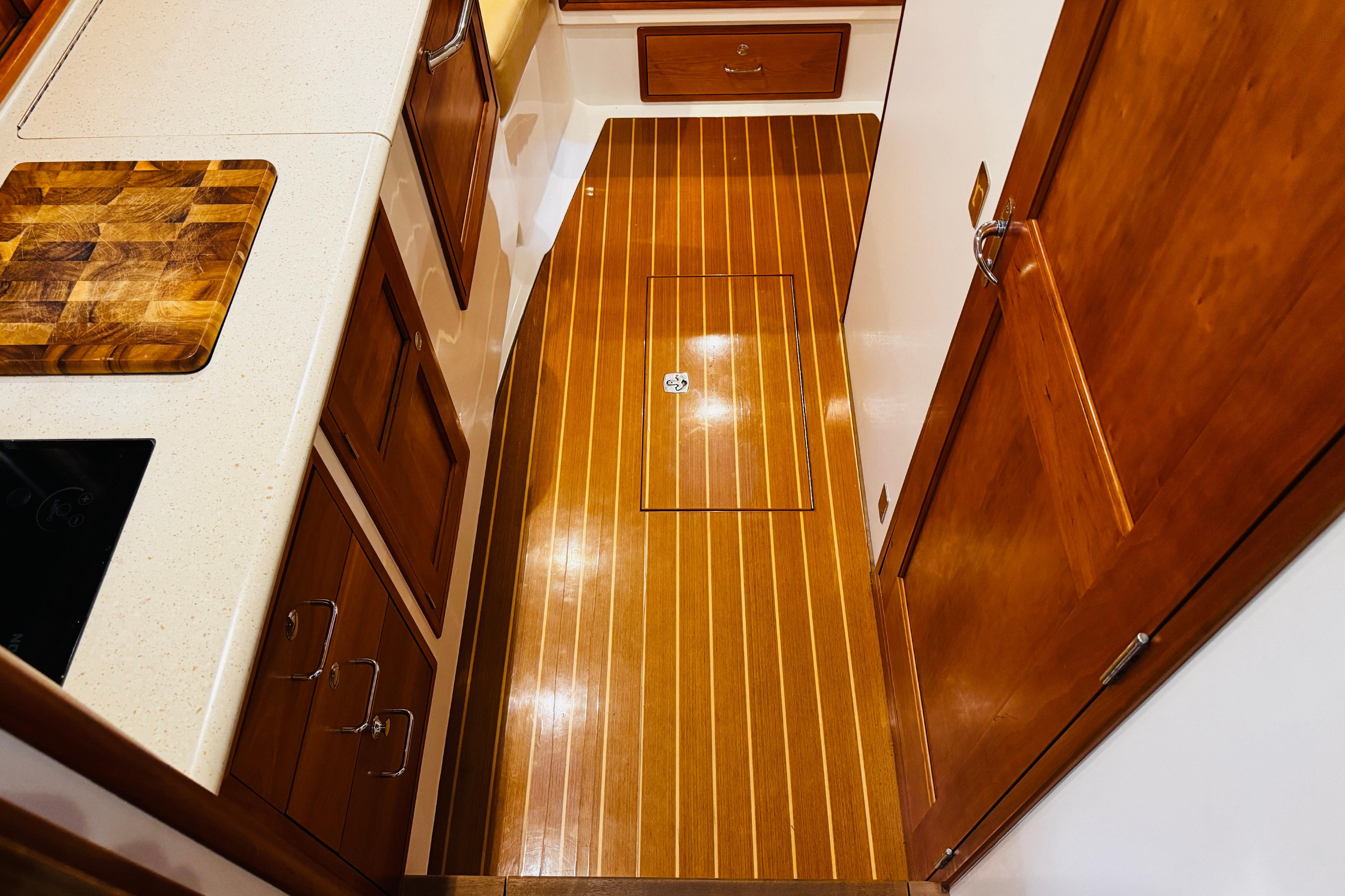 2015 MJM 36z Express yacht interior with wooden flooring and cabinetry.