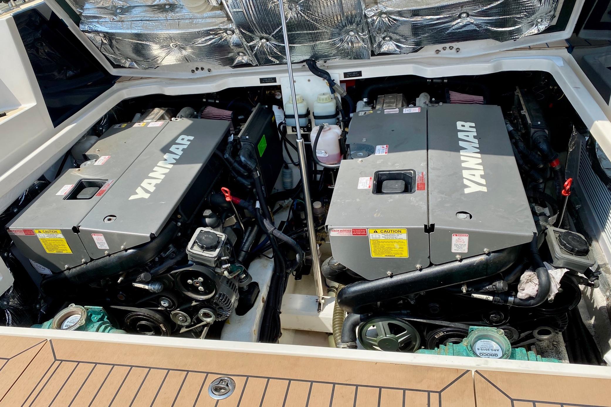 Twin Yanmar engines in a 2015 MJM 36z Express boat, showcasing engine compartment.