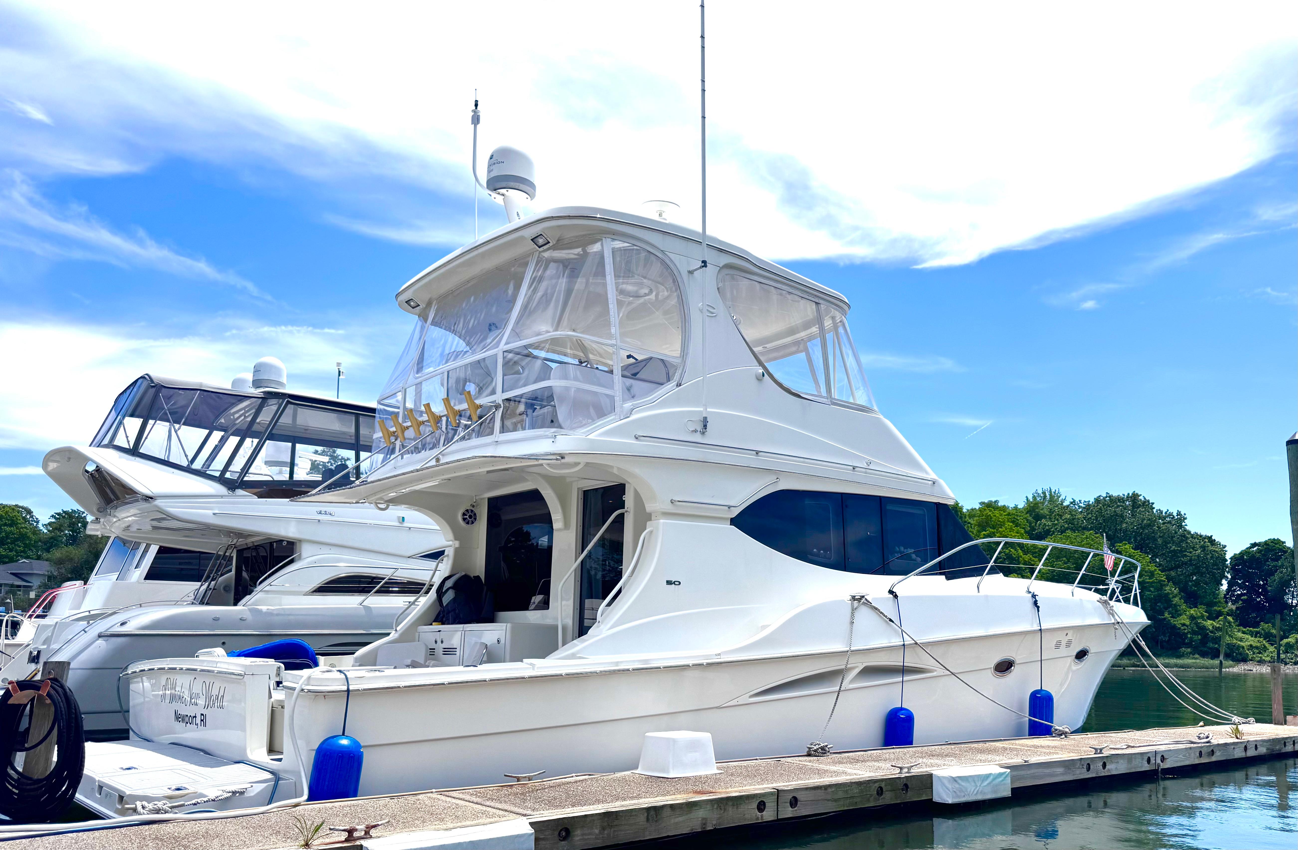 Picture of A Whole New World Silverton 51.58 ft' 50 Convertible 2006 Silverton 50 Convertible yacht docked under a clear blue sky. 