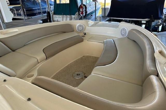 Interior seating of 2002 Sea Ray 240 Sundeck boat, featuring beige and gray upholstery.