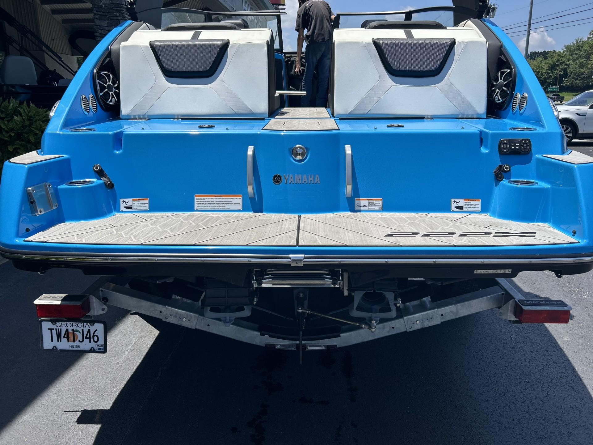 2023 Yamaha Boats 222 XD, blue exterior, rear view, parked on trailer.