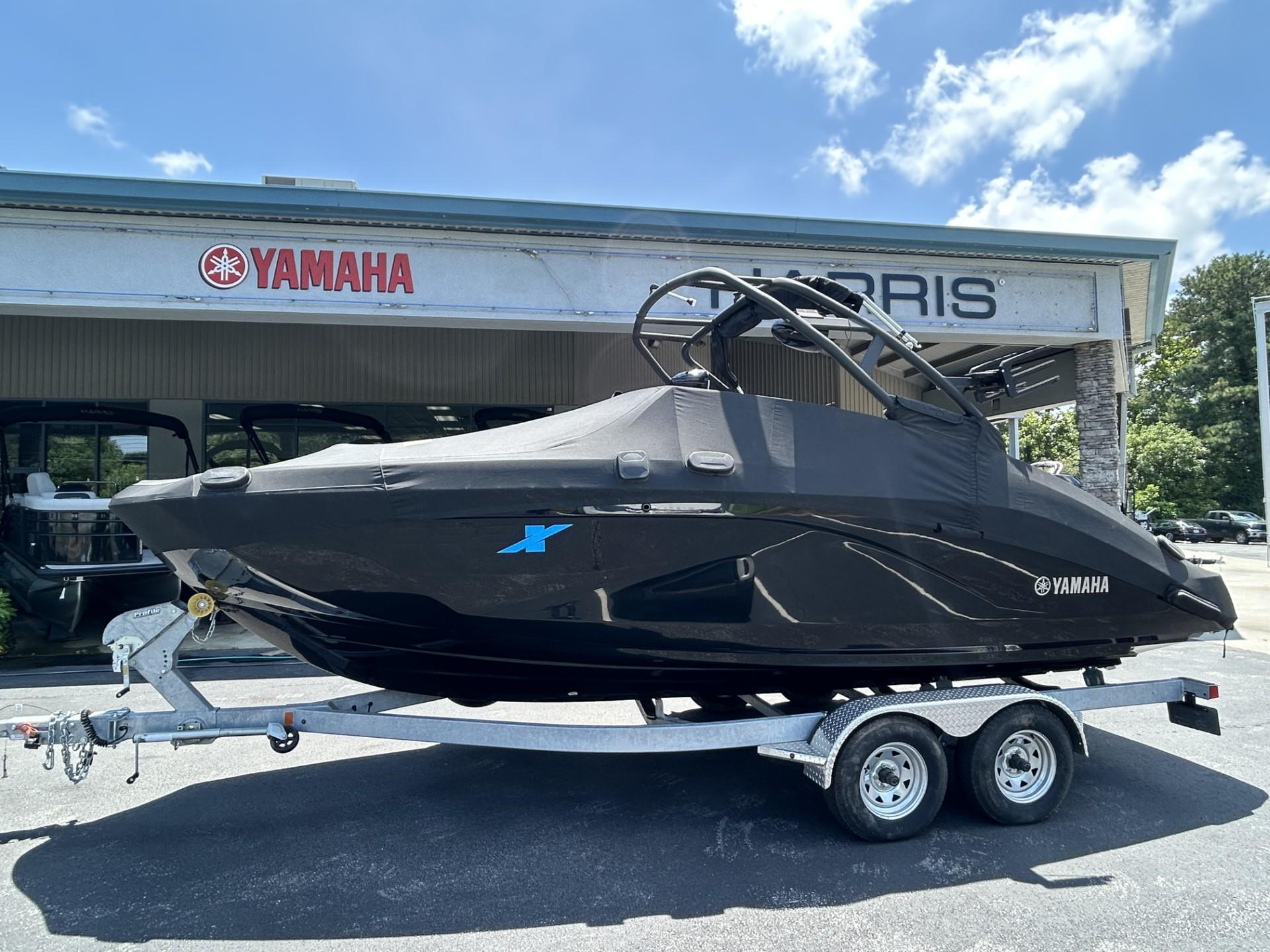 2023 Yamaha Boats 222 XD on trailer, covered, outside dealership.