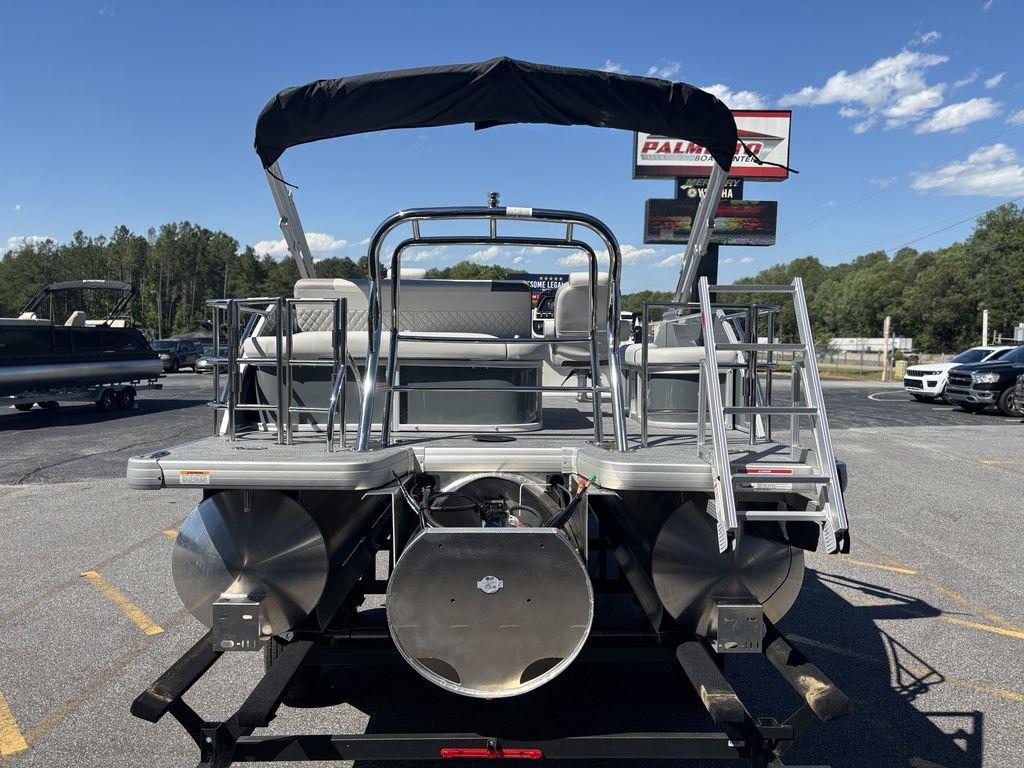2025 Godfrey Sweetwater 2286 SFLC pontoon boat, rear view, parked outdoors under clear sky.