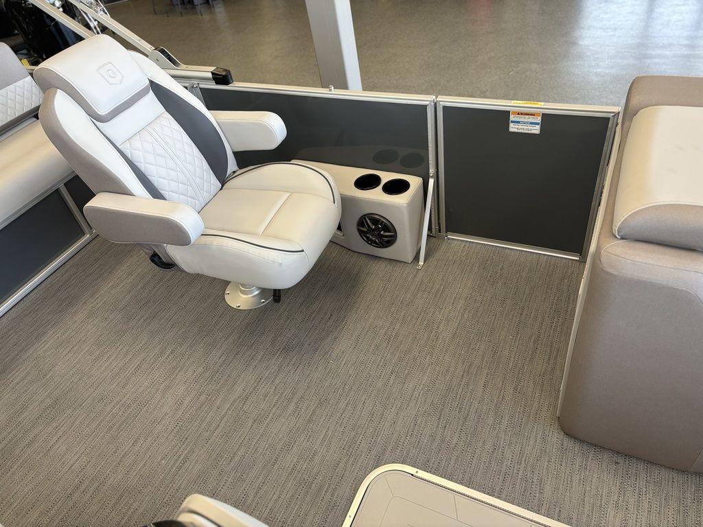 Luxurious seating on 2025 Godfrey Sweetwater 2286 SFLC boat with cup holders and speaker.