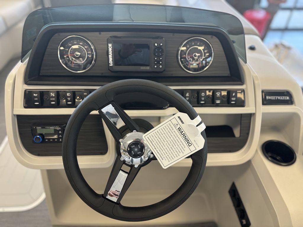 Steering console of 2025 Godfrey Sweetwater 2286 SFLC boat with gauges and controls.