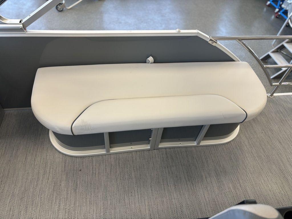 2025 Godfrey Sweetwater 2286 SFLC boat seat with gray upholstery and metal railing.
