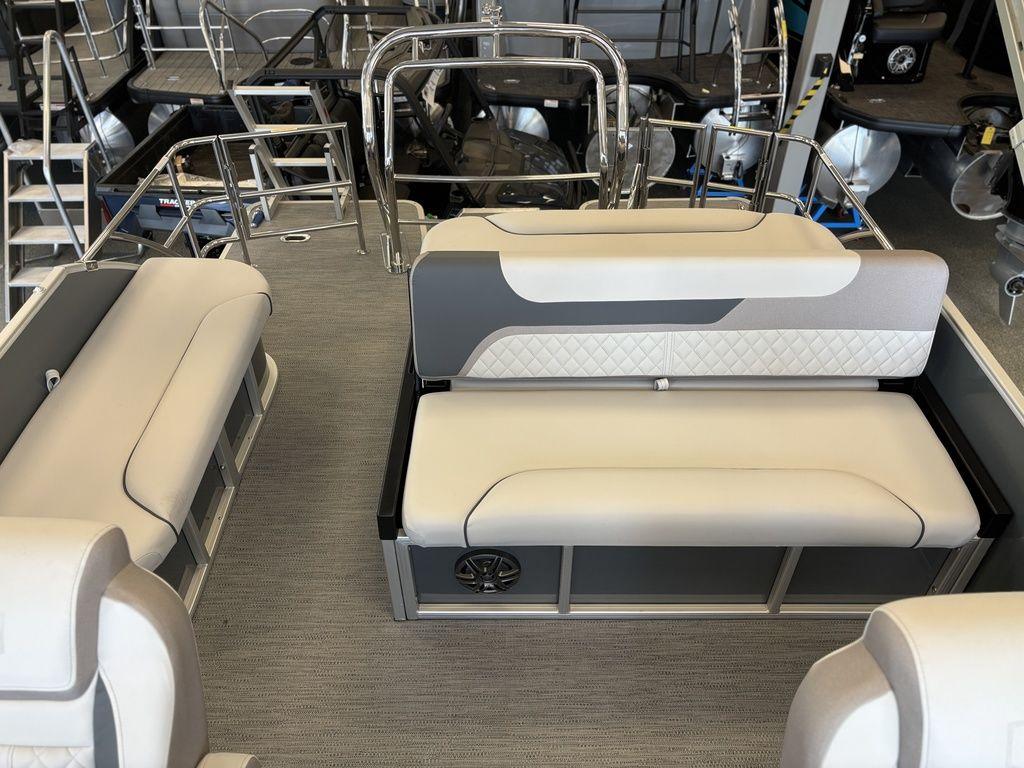 2025 Godfrey Sweetwater 2286 SFLC boat interior with beige seating and metal railings.