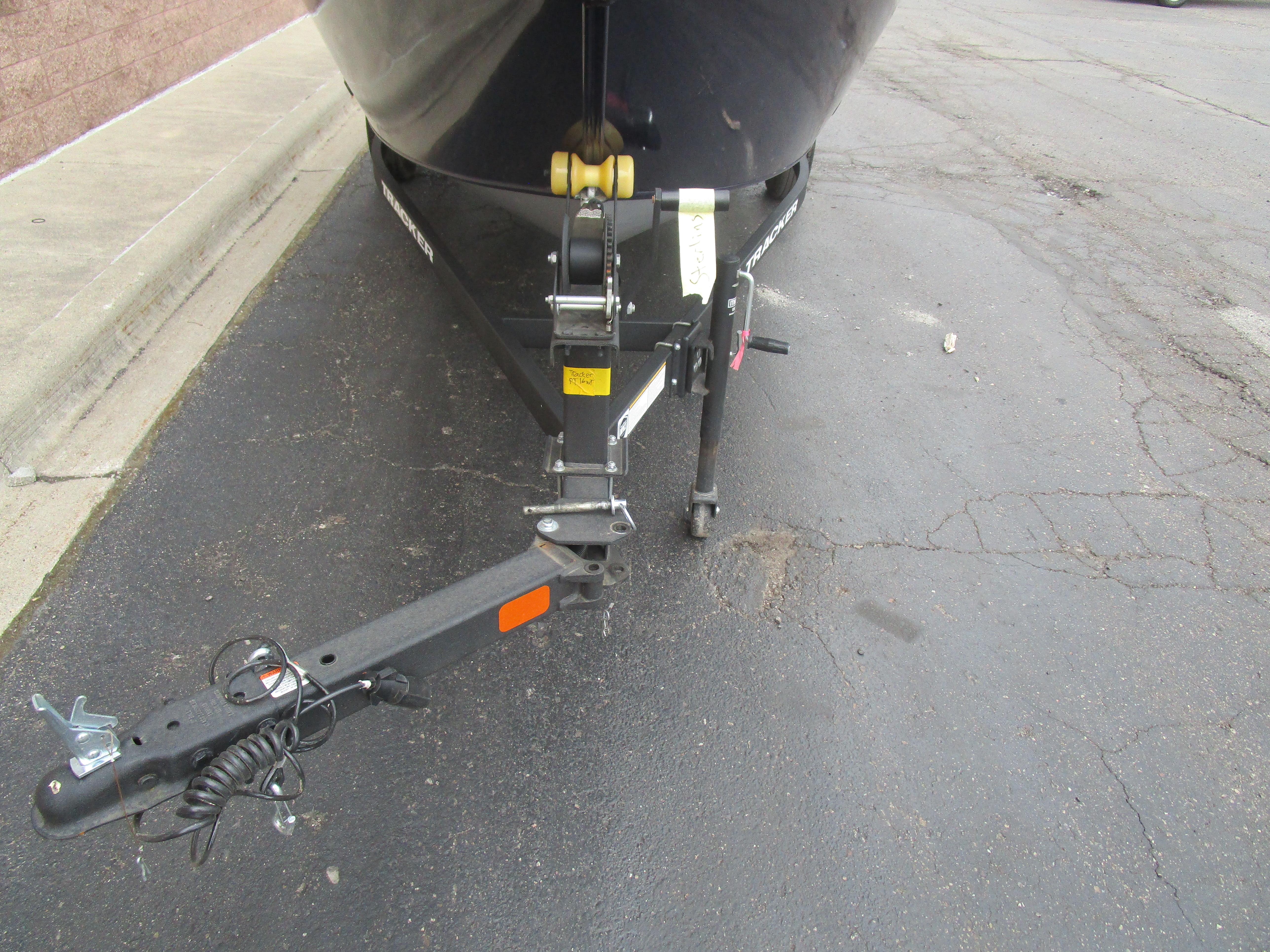 2025 Tracker Pro Guide V16 WT boat trailer hitch on pavement.
