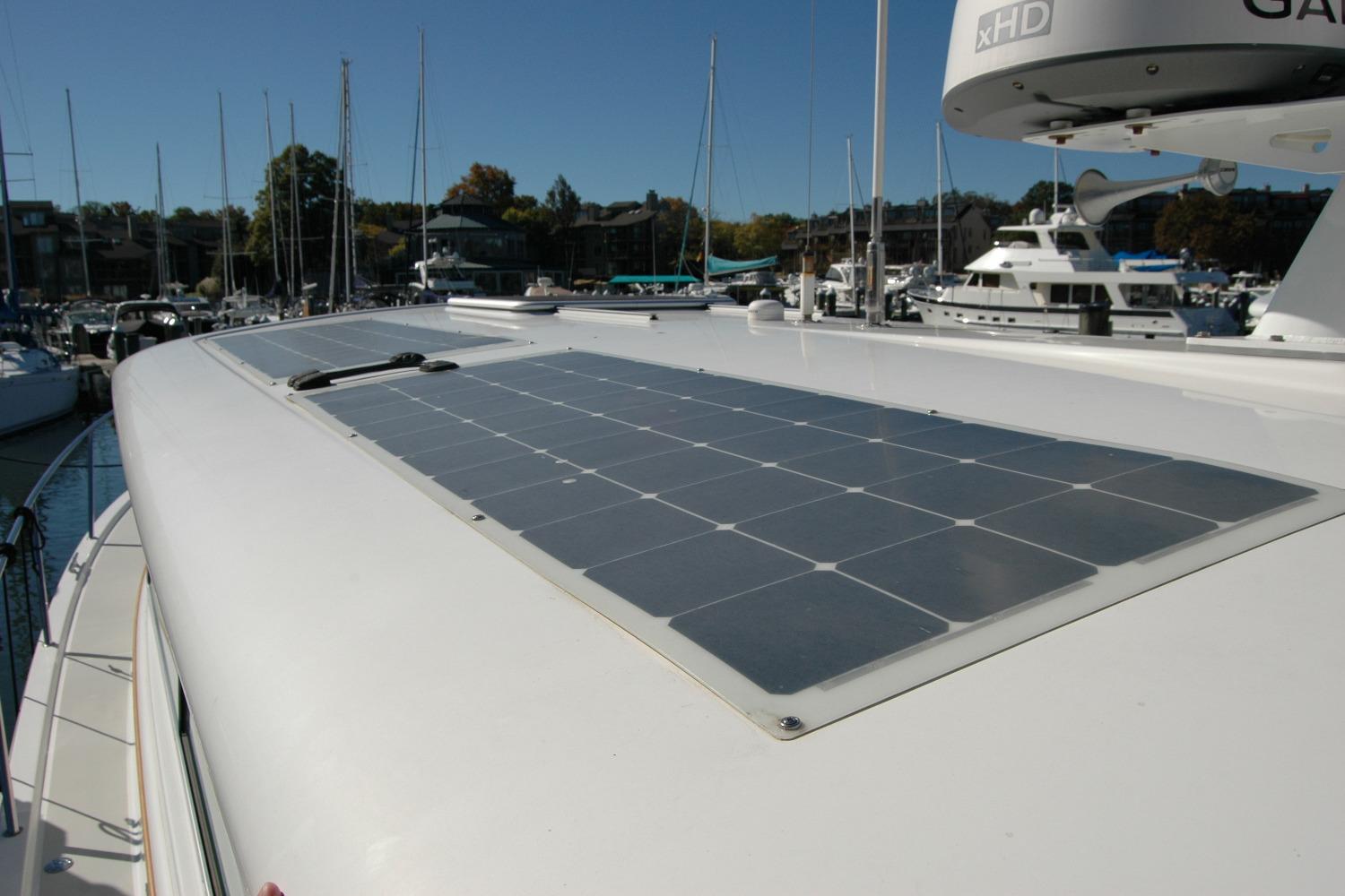 2015 Back Cove 37 yacht with solar panels on deck, docked in marina.