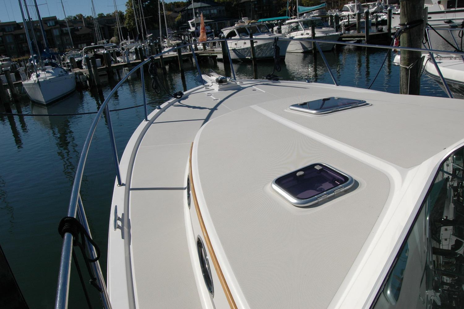 2015 Back Cove 37 yacht deck, docked in a marina with other boats.