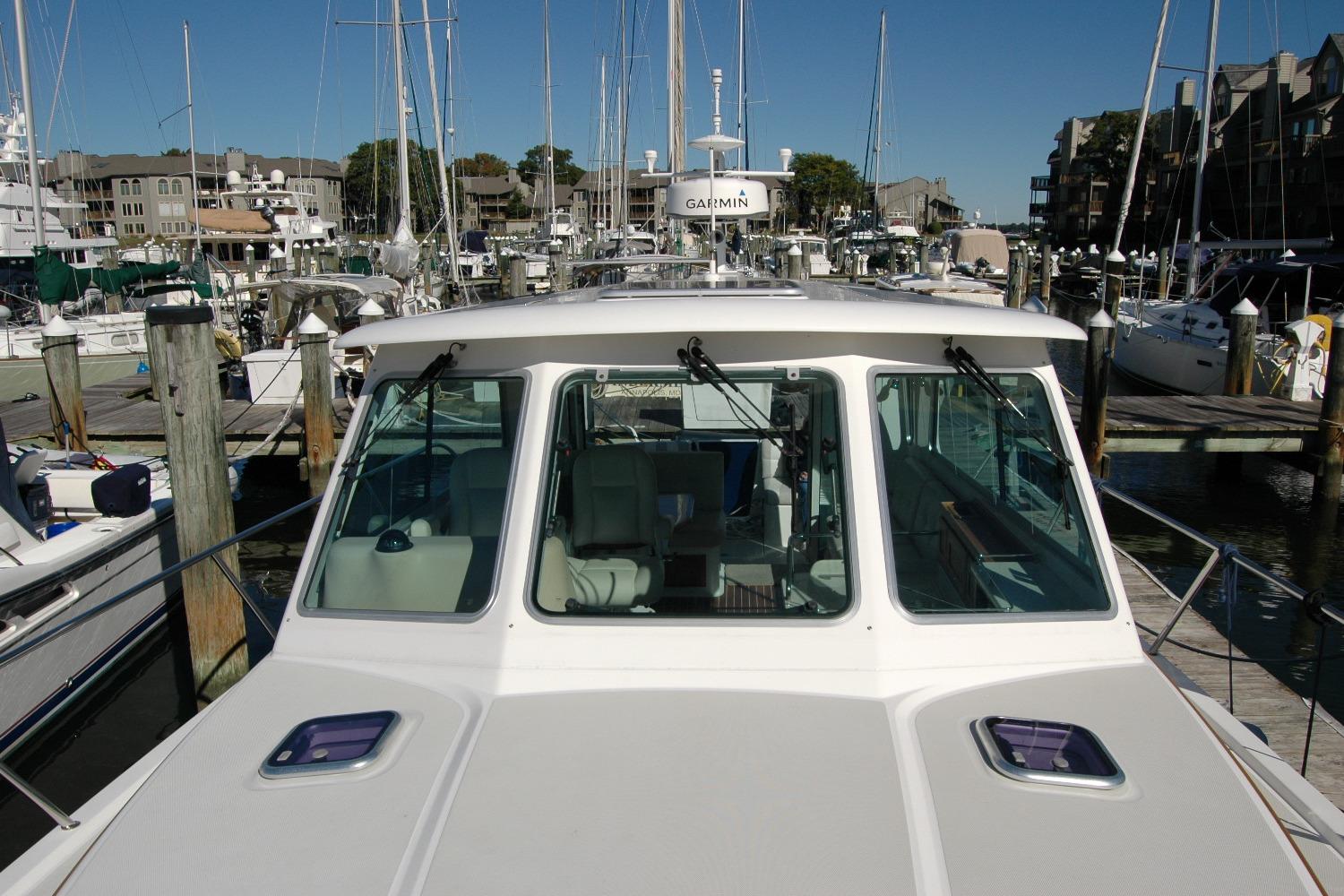 2015 Back Cove 37 yacht docked at a marina, surrounded by other boats.