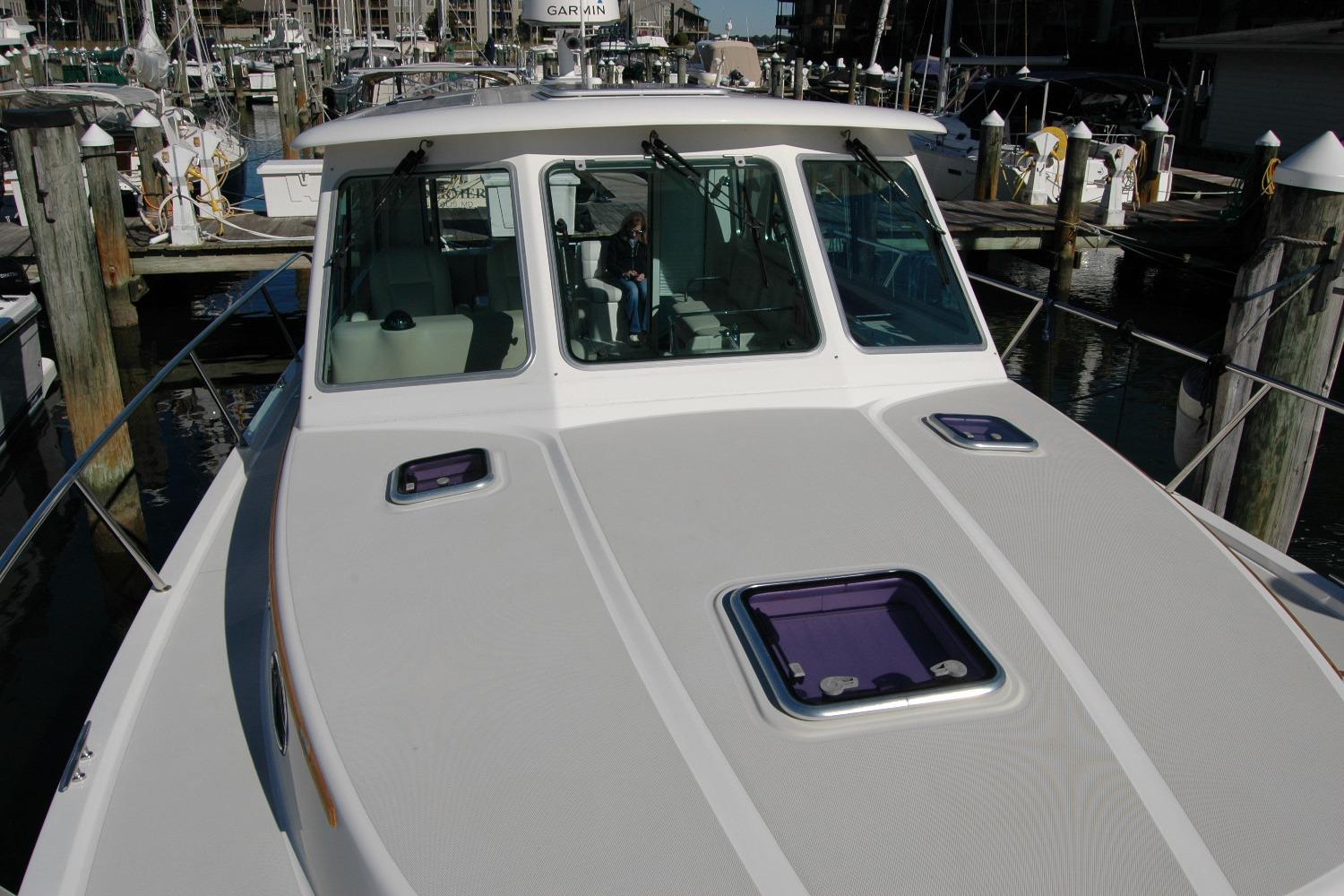 2015 Back Cove 37 yacht docked at marina, showcasing sleek design and spacious deck.