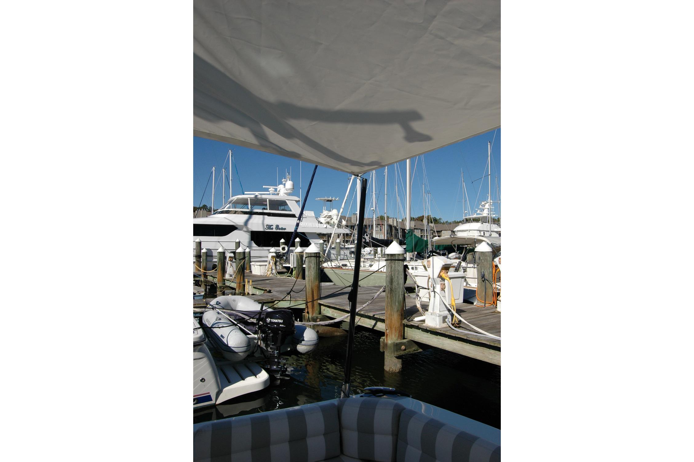 2015 Back Cove 37 docked at marina with other boats under clear blue sky.