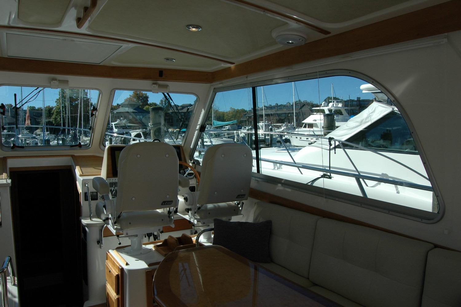 Interior view of 2015 Back Cove 37 yacht with marina background.