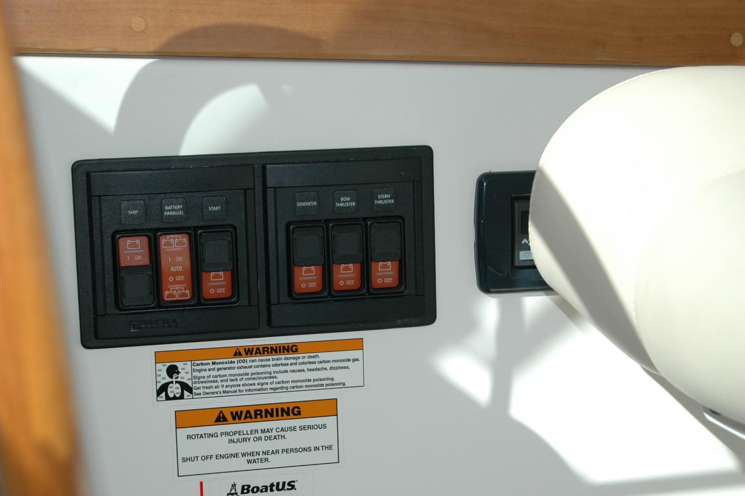 Control panel on a 2015 Back Cove 37 boat with warning labels.