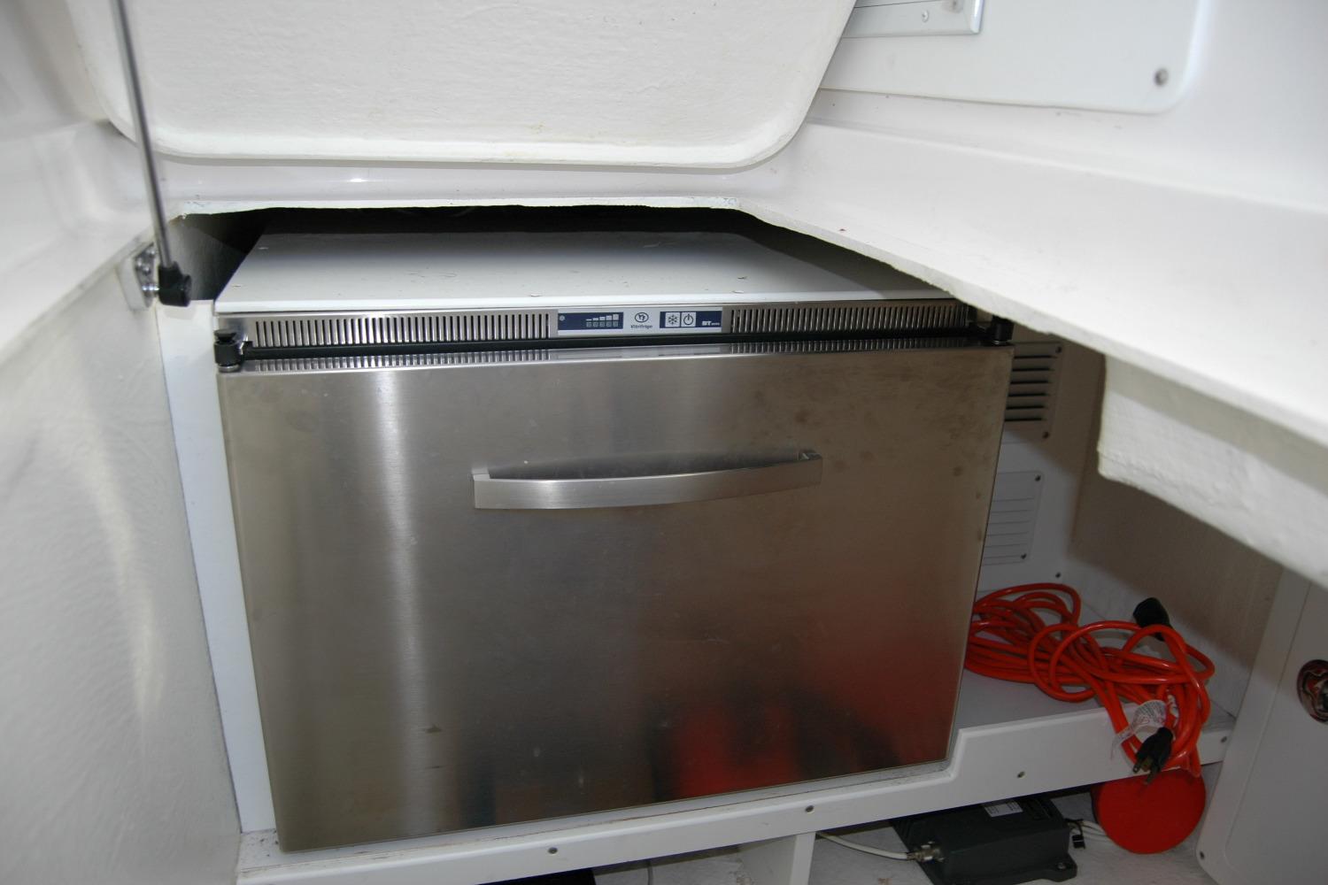 Stainless steel refrigerator in 2015 Back Cove 37 boat interior.