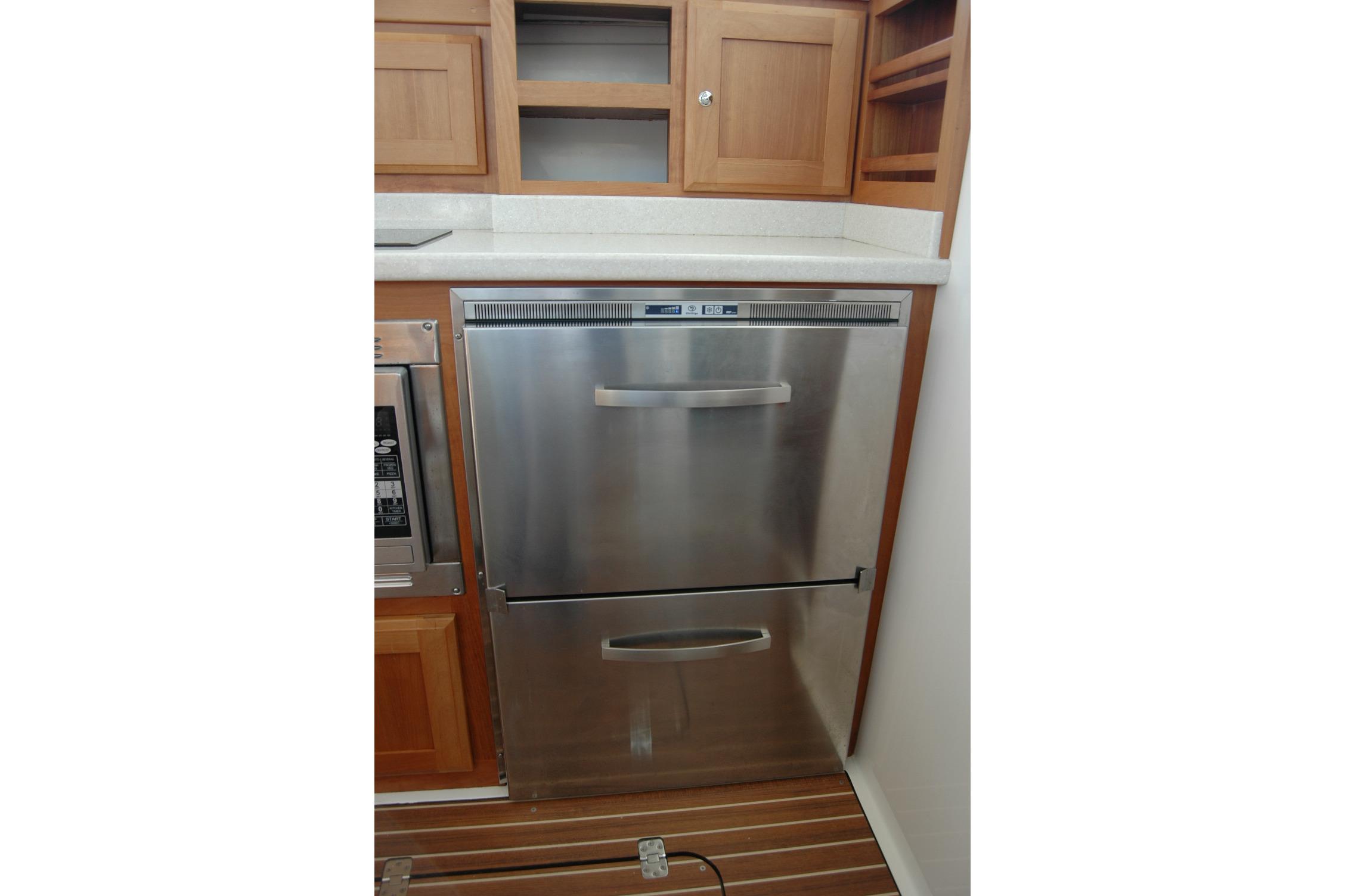 Stainless steel refrigerator in 2015 Back Cove 37 yacht kitchen.