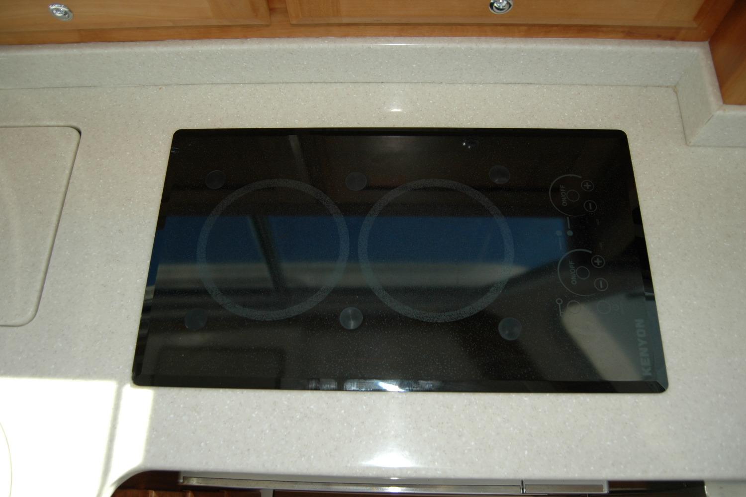 Stovetop on 2015 Back Cove 37 yacht, featuring sleek black glass design.