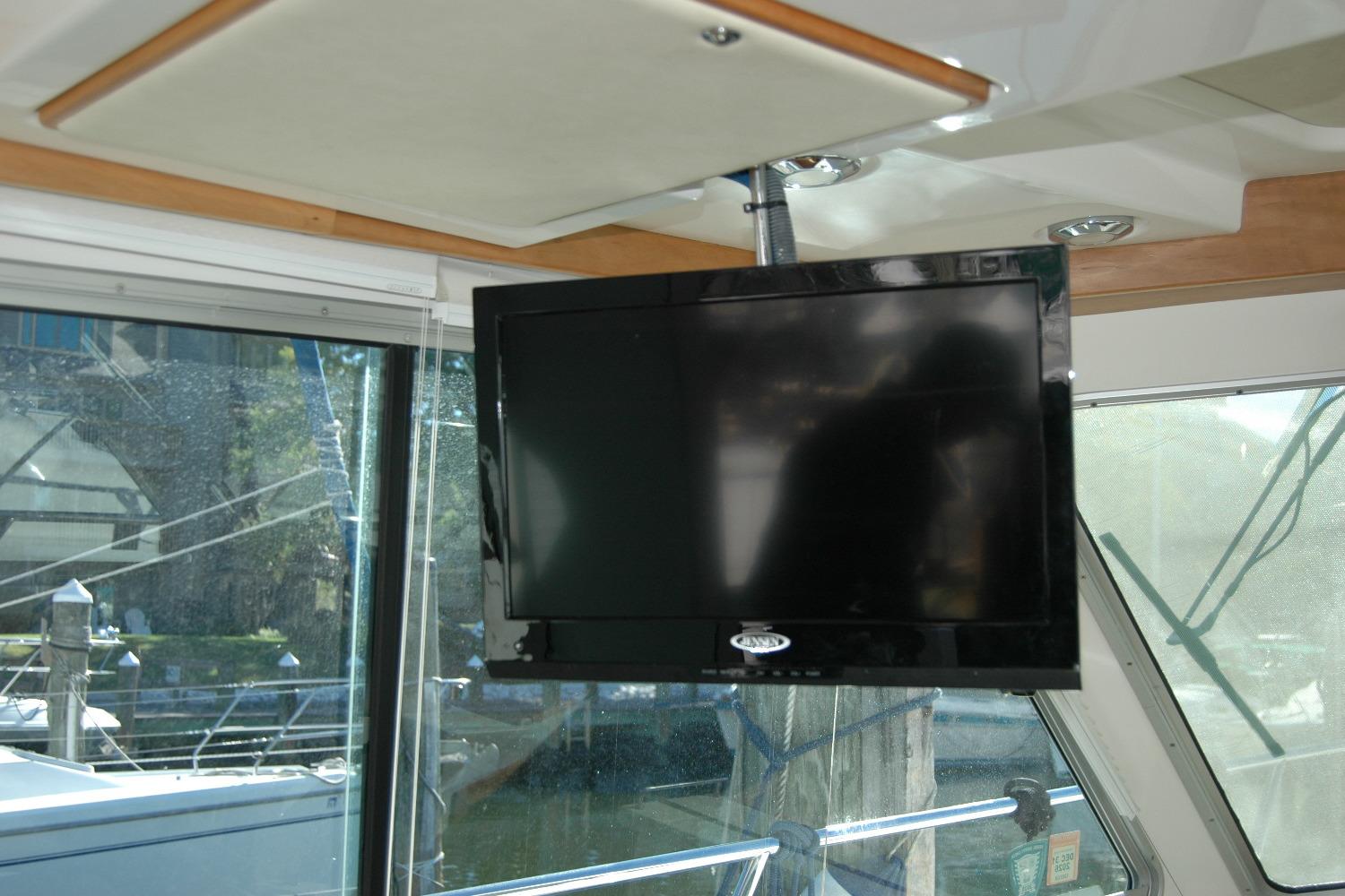 Flat-screen TV inside 2015 Back Cove 37 boat, near large windows.