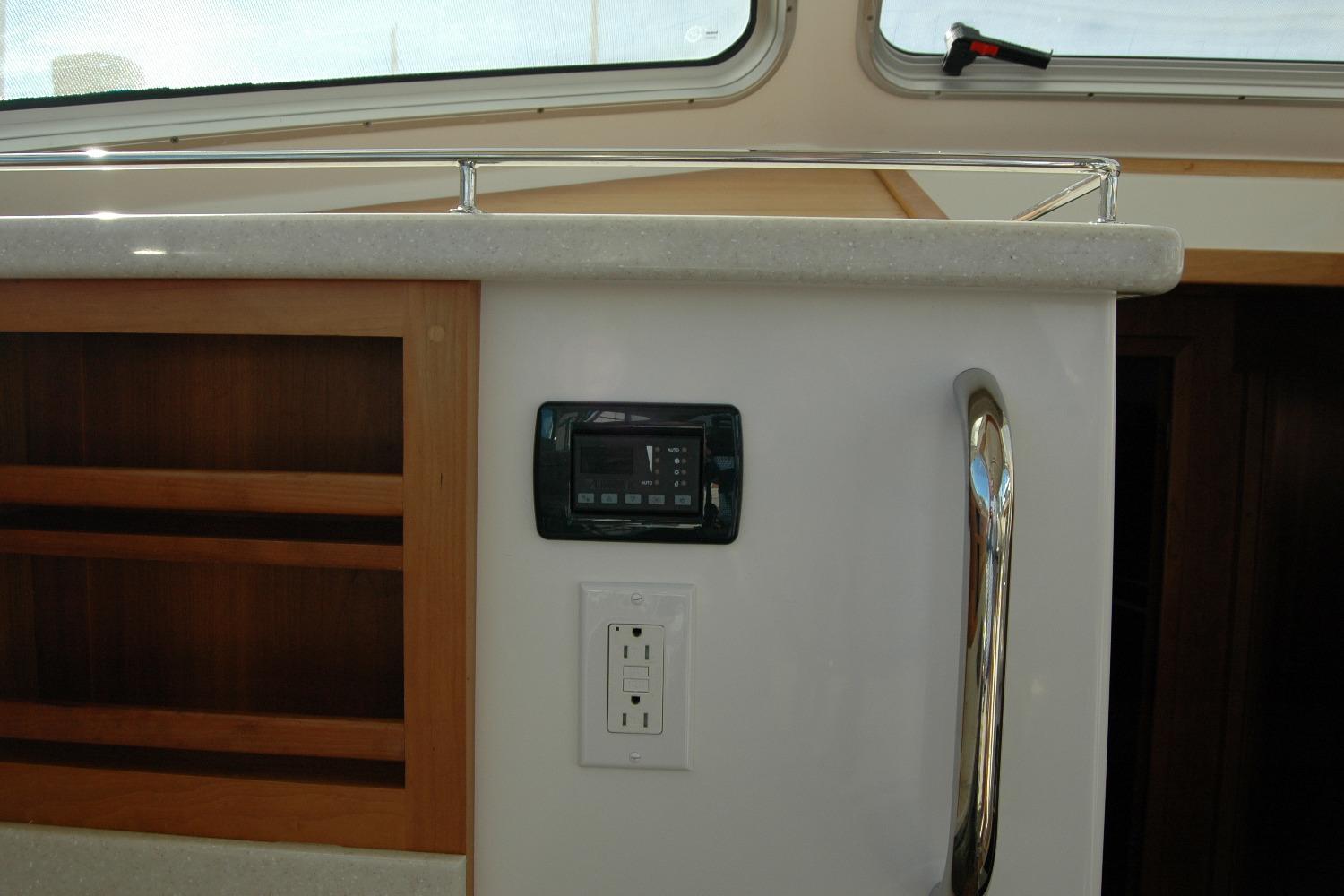 Interior of 2015 Back Cove 37 yacht with control panel and power outlet.