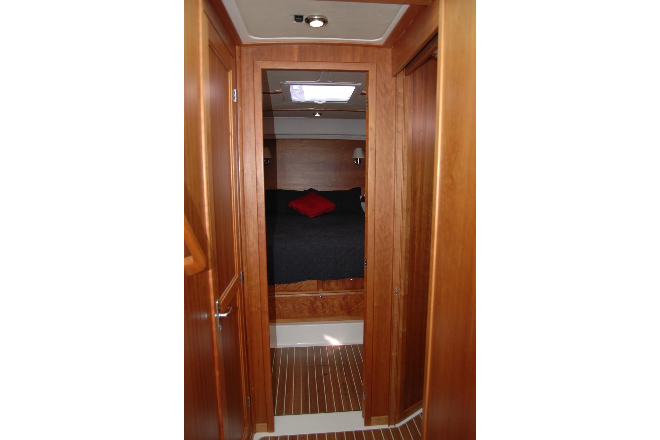 2015 Back Cove 37 yacht interior with wood finish and cozy bedroom.