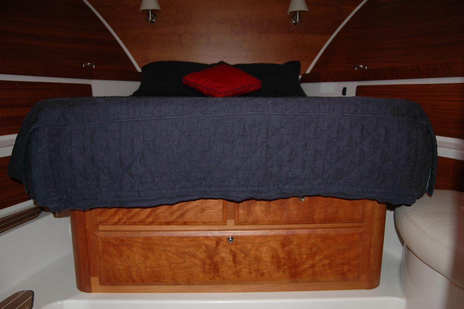 2015 Back Cove 37 cabin interior with wooden storage and cozy bedding.