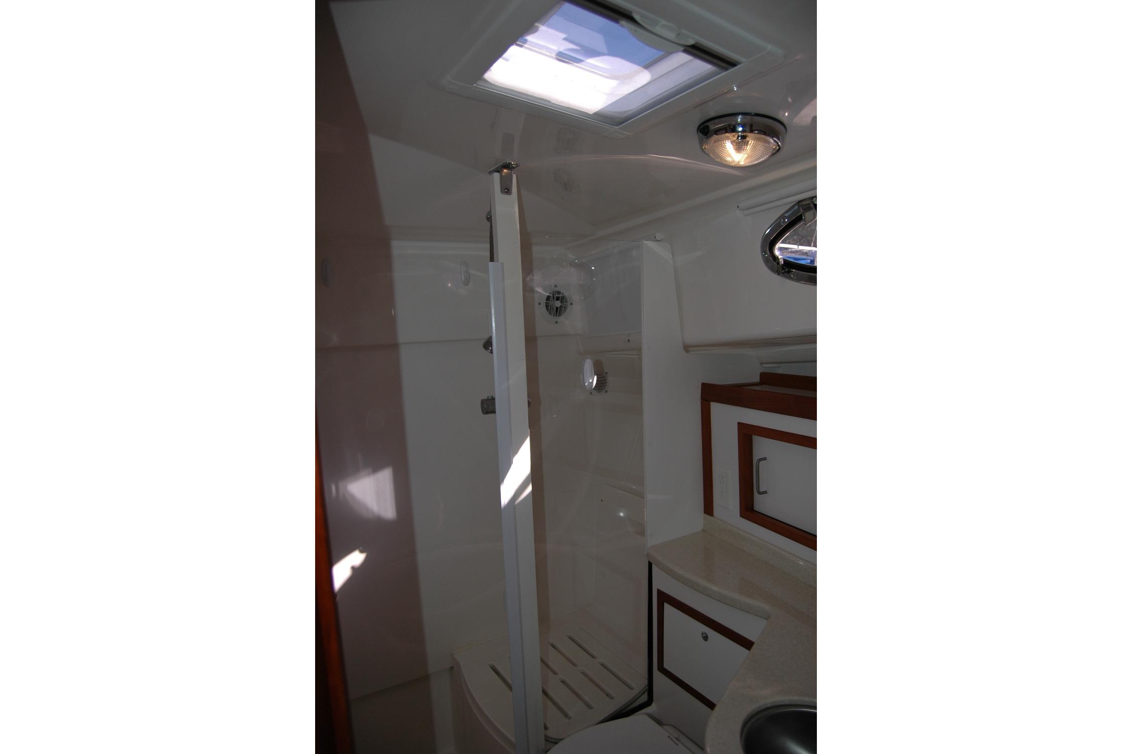 2015 Back Cove 37 yacht bathroom with shower, skylight, and modern fixtures.