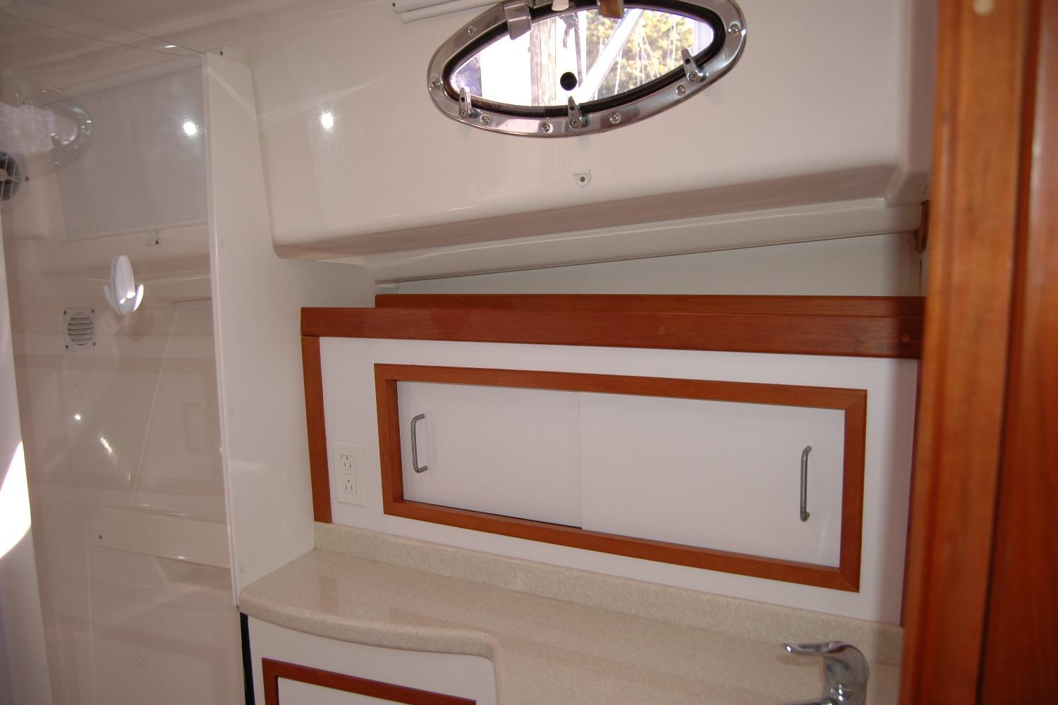 2015 Back Cove 37 yacht interior with wooden cabinetry and porthole window.