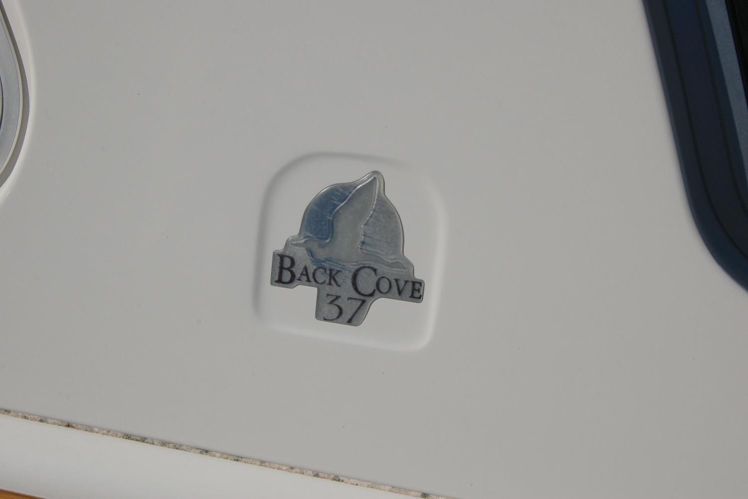 2015 Back Cove 37 emblem on boat exterior.