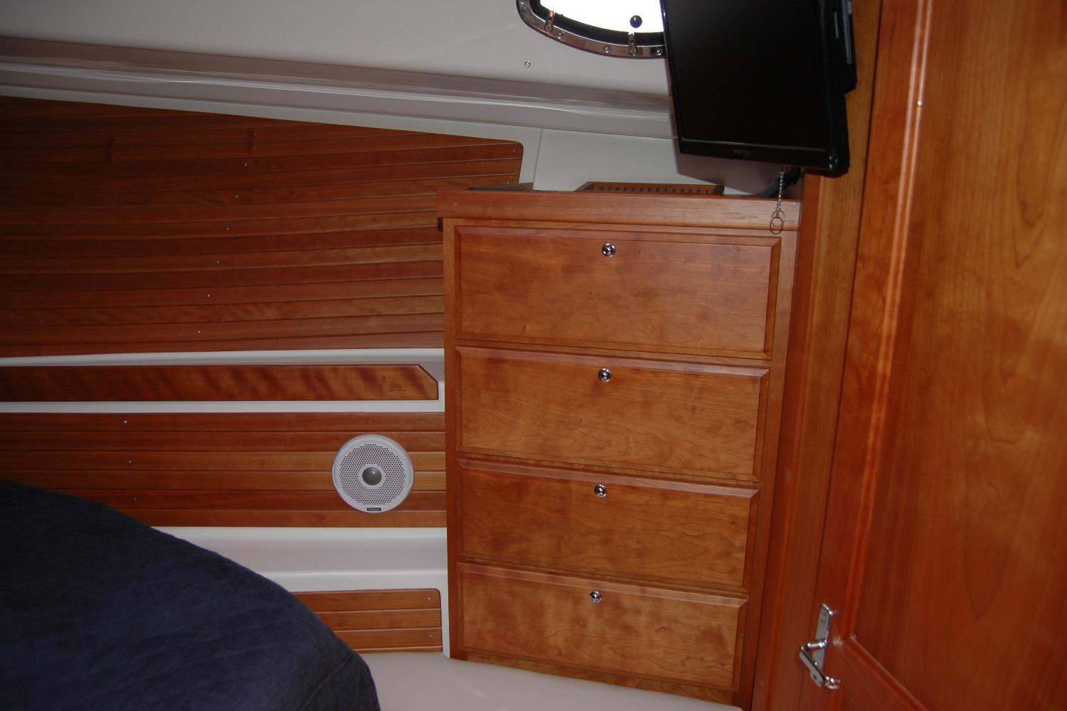 Interior of 2015 Back Cove 37 yacht with wooden cabinetry and speaker.