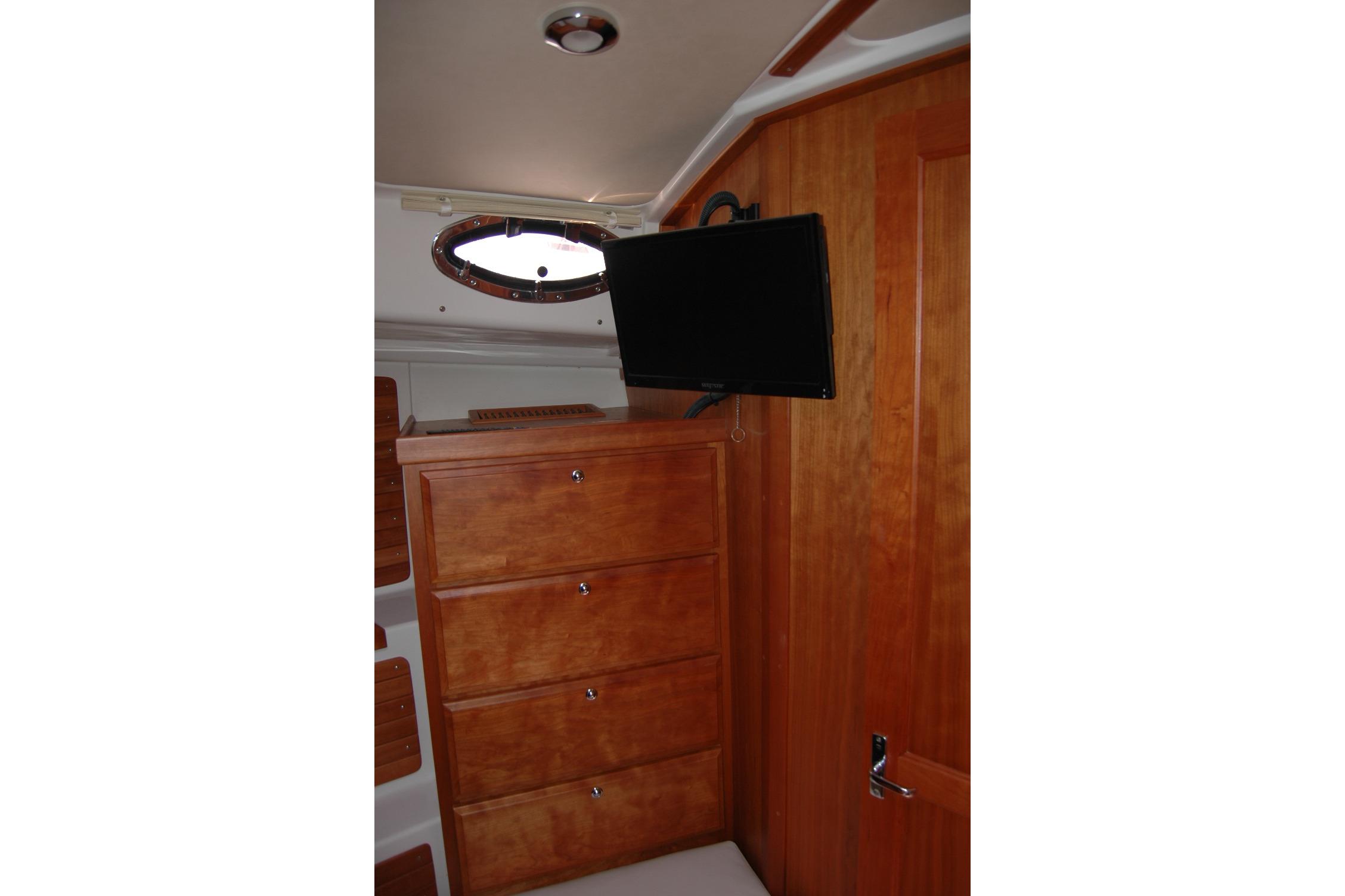 2015 Back Cove 37 interior with wooden cabinetry and mounted TV.