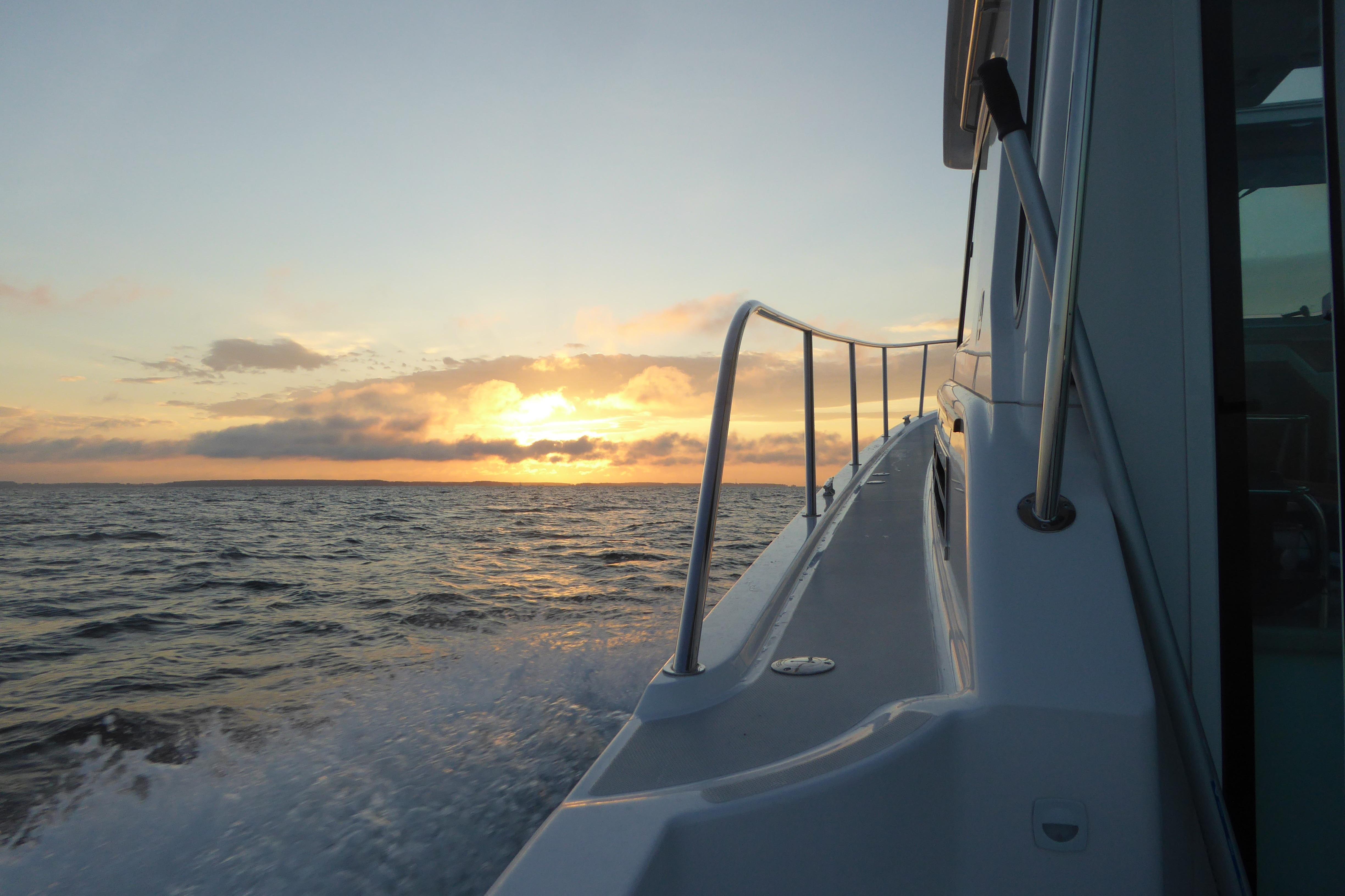Back Cove 37 boat cruising at sunset, 2015 model, ocean view.