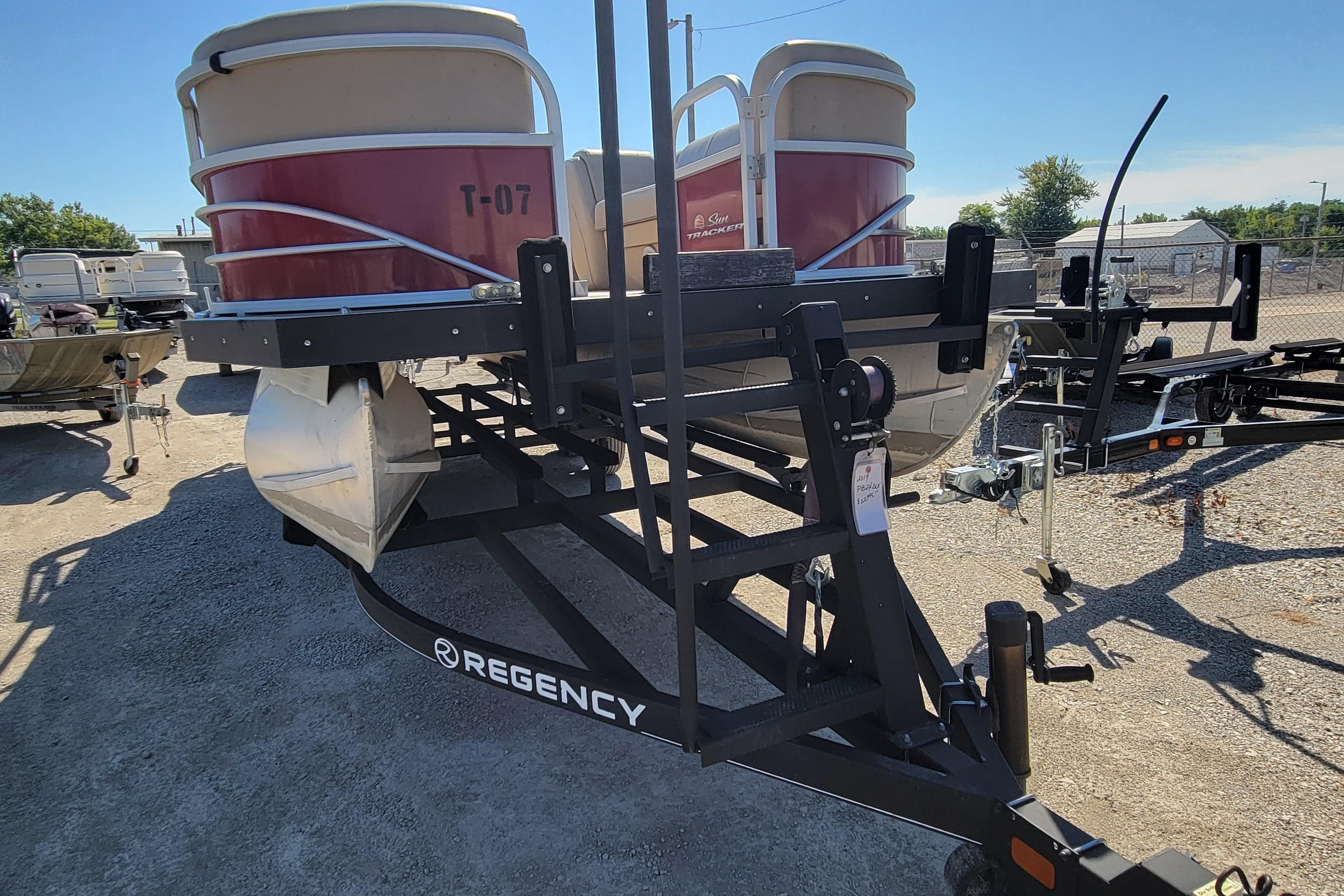 2019 Sun Tracker Party Barge 24 DLX on trailer in outdoor lot.