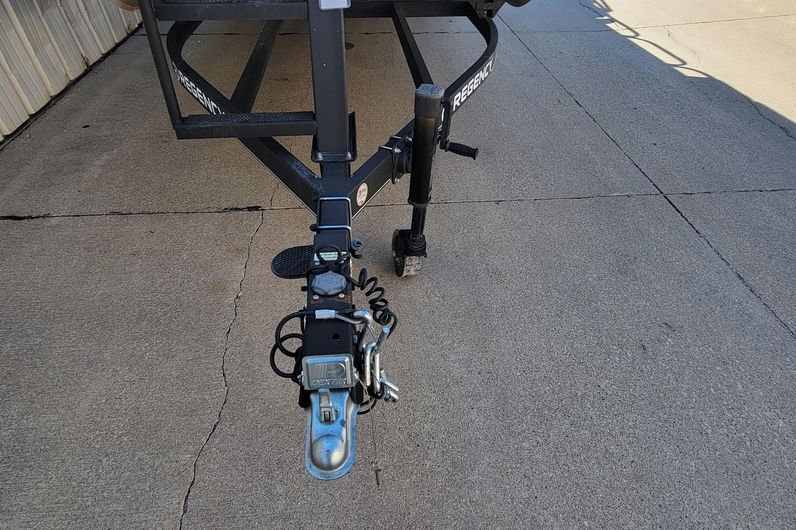 Trailer hitch of a 2019 Sun Tracker Party Barge 24 DLX on concrete surface.
