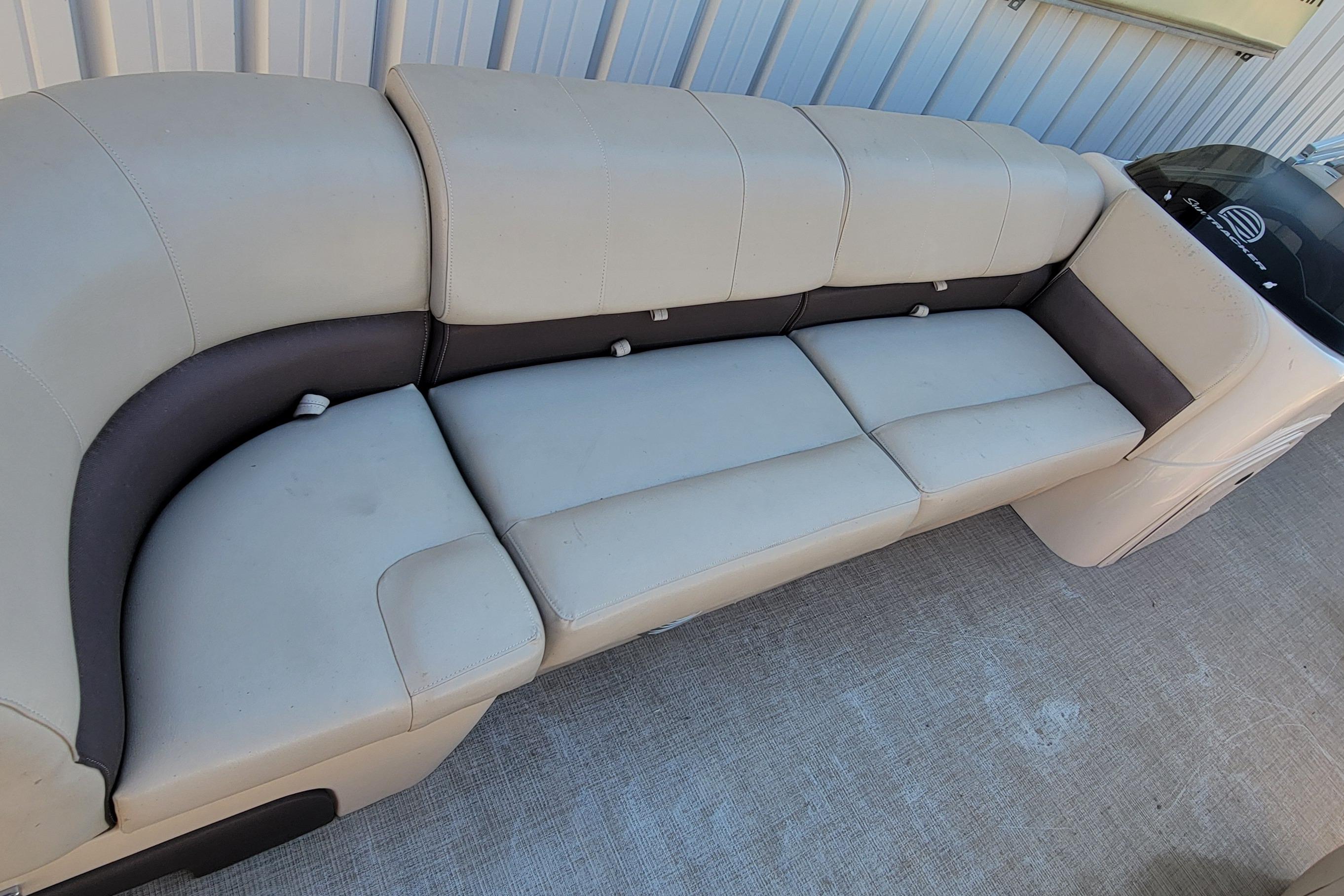 2019 Sun Tracker Party Barge 24 DLX interior seating, beige and brown upholstery.