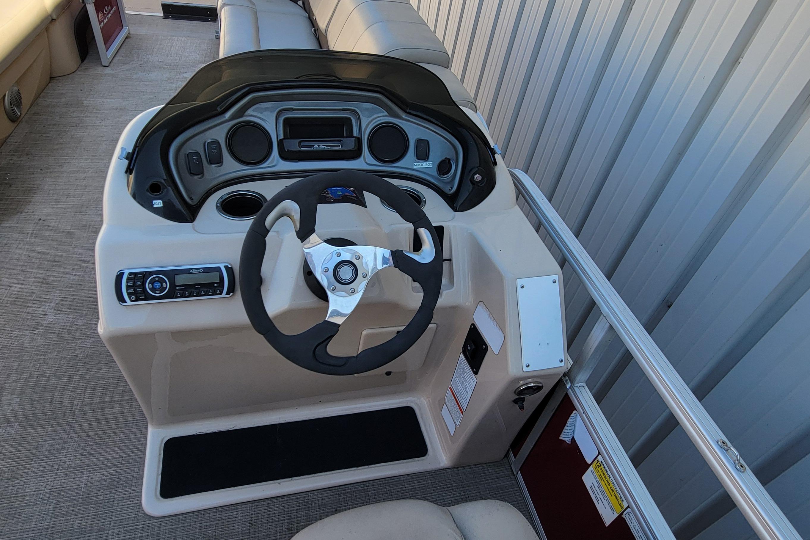 2019 Sun Tracker Party Barge 24 DLX helm with steering wheel and control panel.