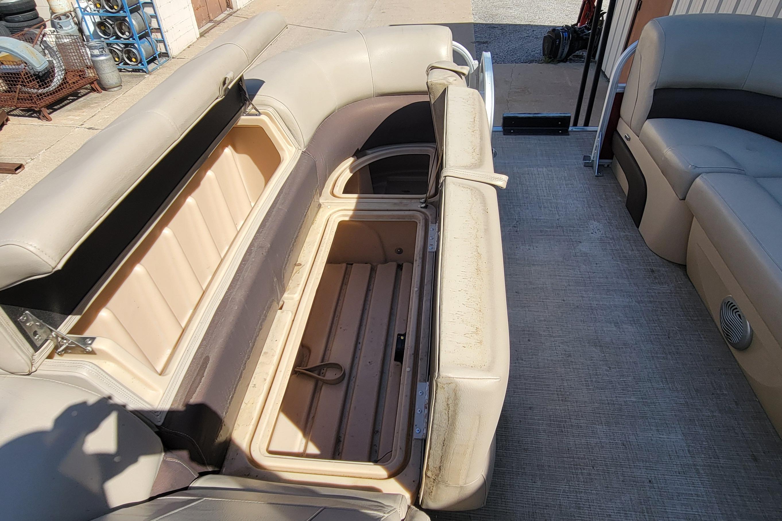 2019 Sun Tracker Party Barge 24 DLX interior with open storage compartment.