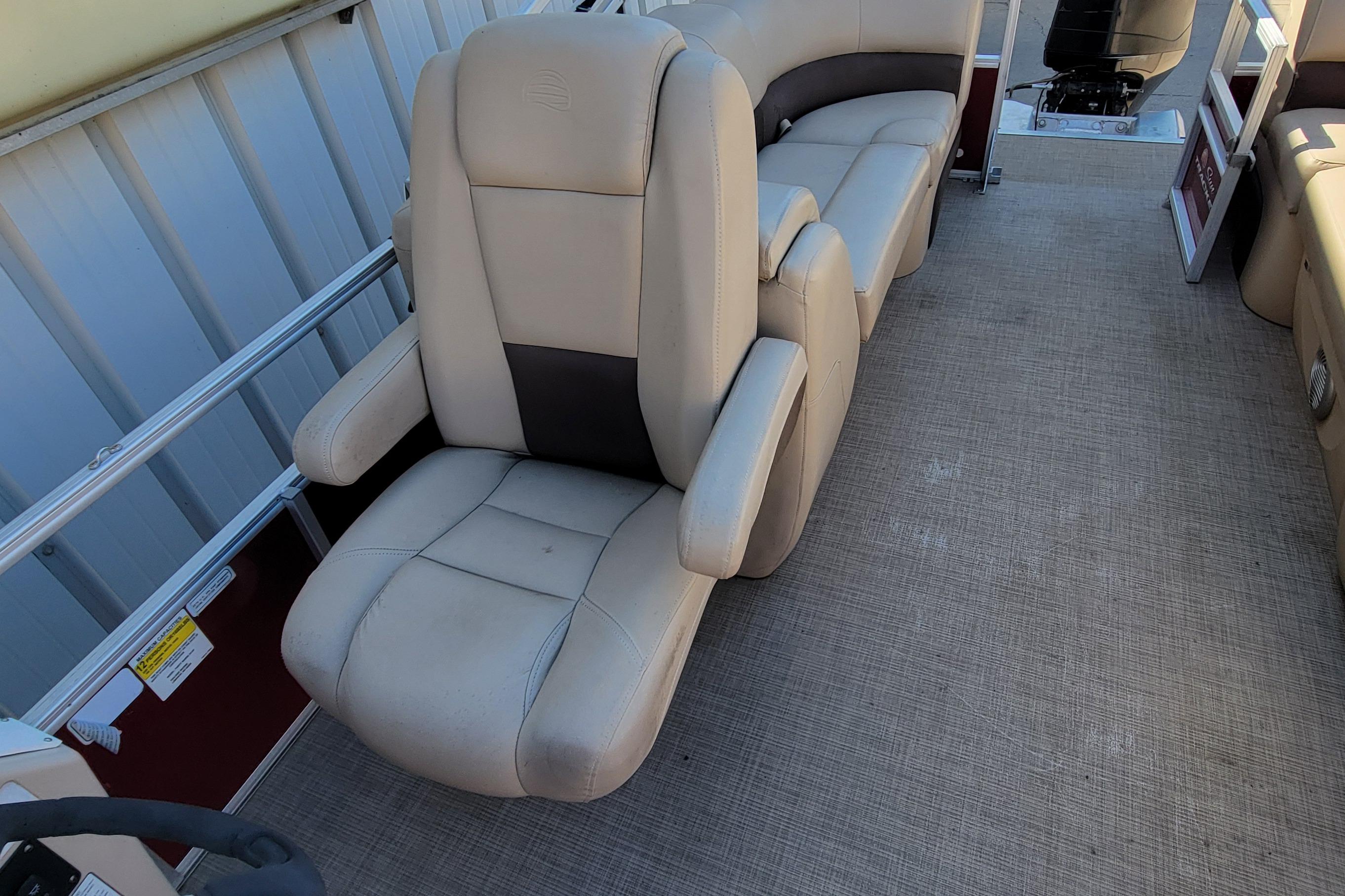 2019 Sun Tracker Party Barge 24 DLX interior with beige seating and spacious layout.