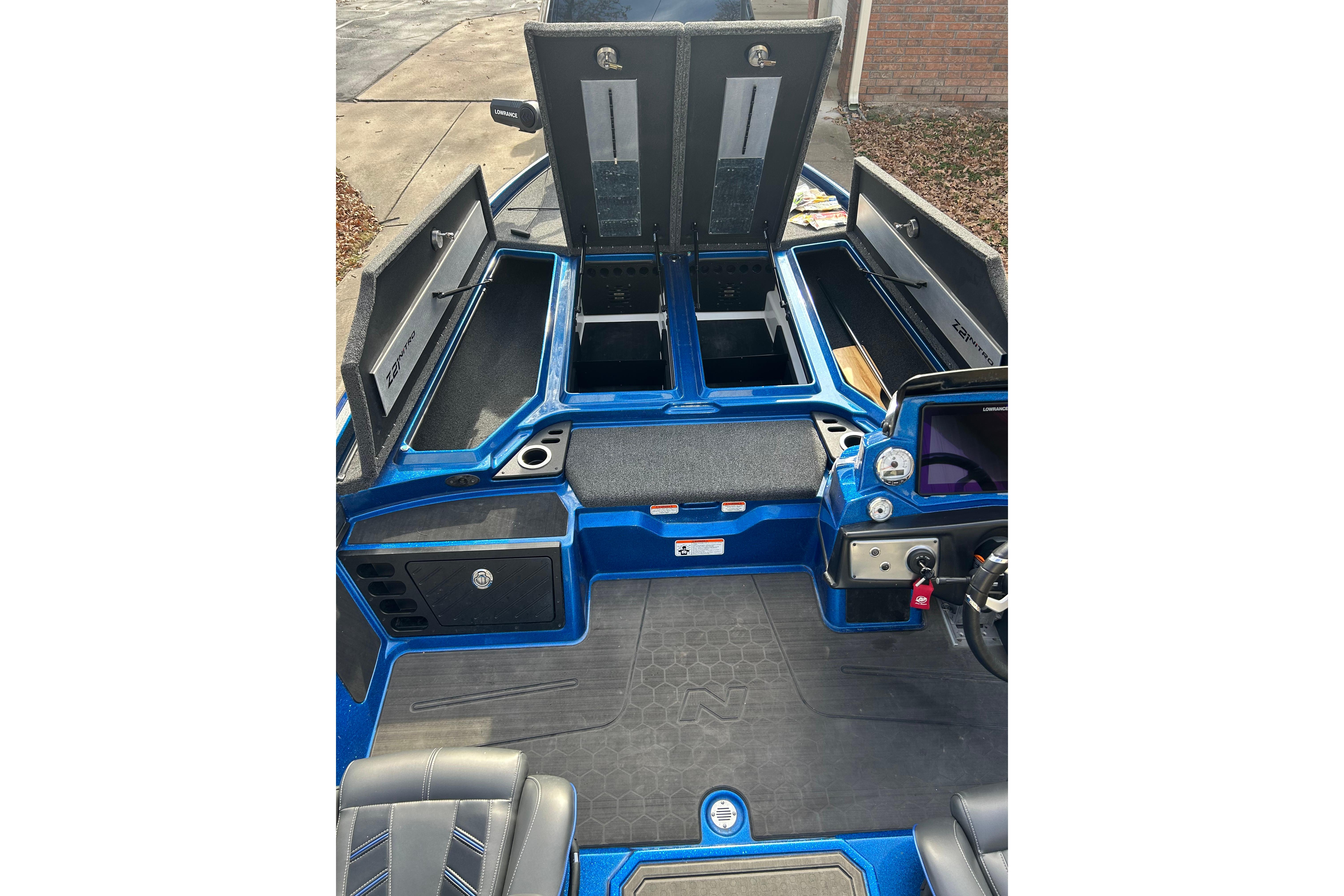 2024 Nitro Z21 XL Pro boat interior with open storage compartments and control panel.