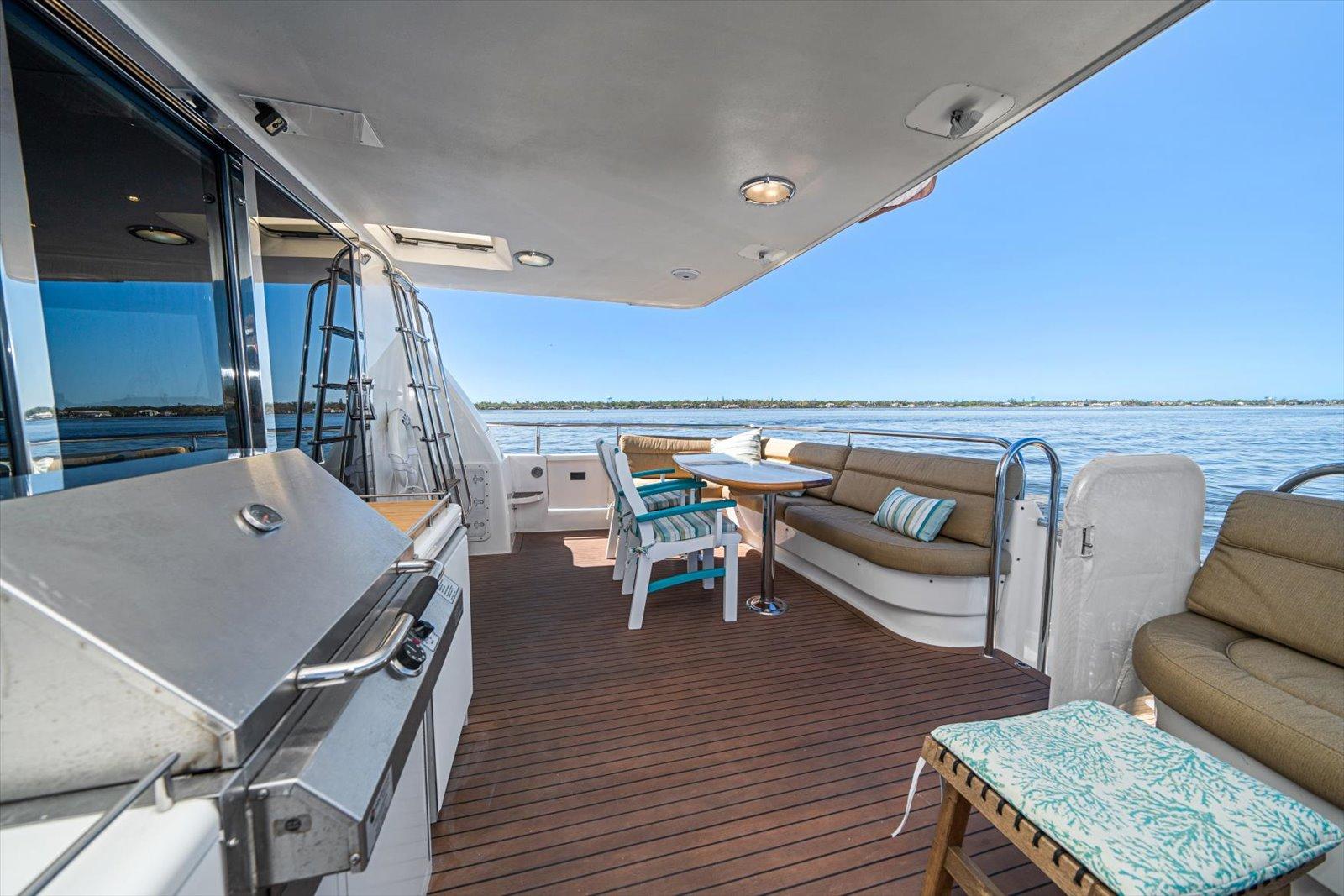 Lazzara-EB 76 1997-Octopi FL-US-Outdoor deck of 1997 Lazzara EB 76 yacht with seating and grill, overlooking water.-9736767 | Thumbnail
